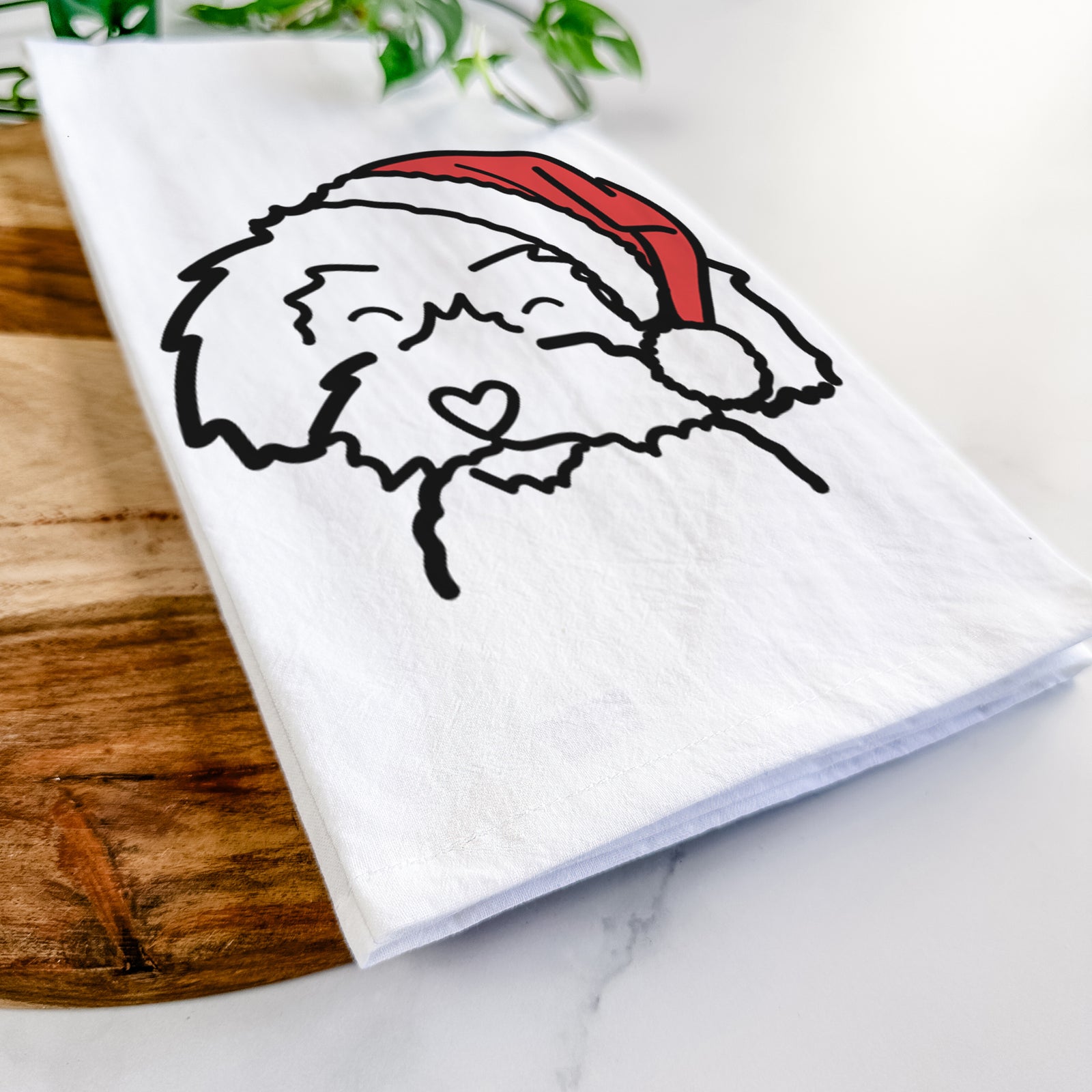 Minimalist line drawing of a Schnoodle wearing a Santa hat on a tea towel