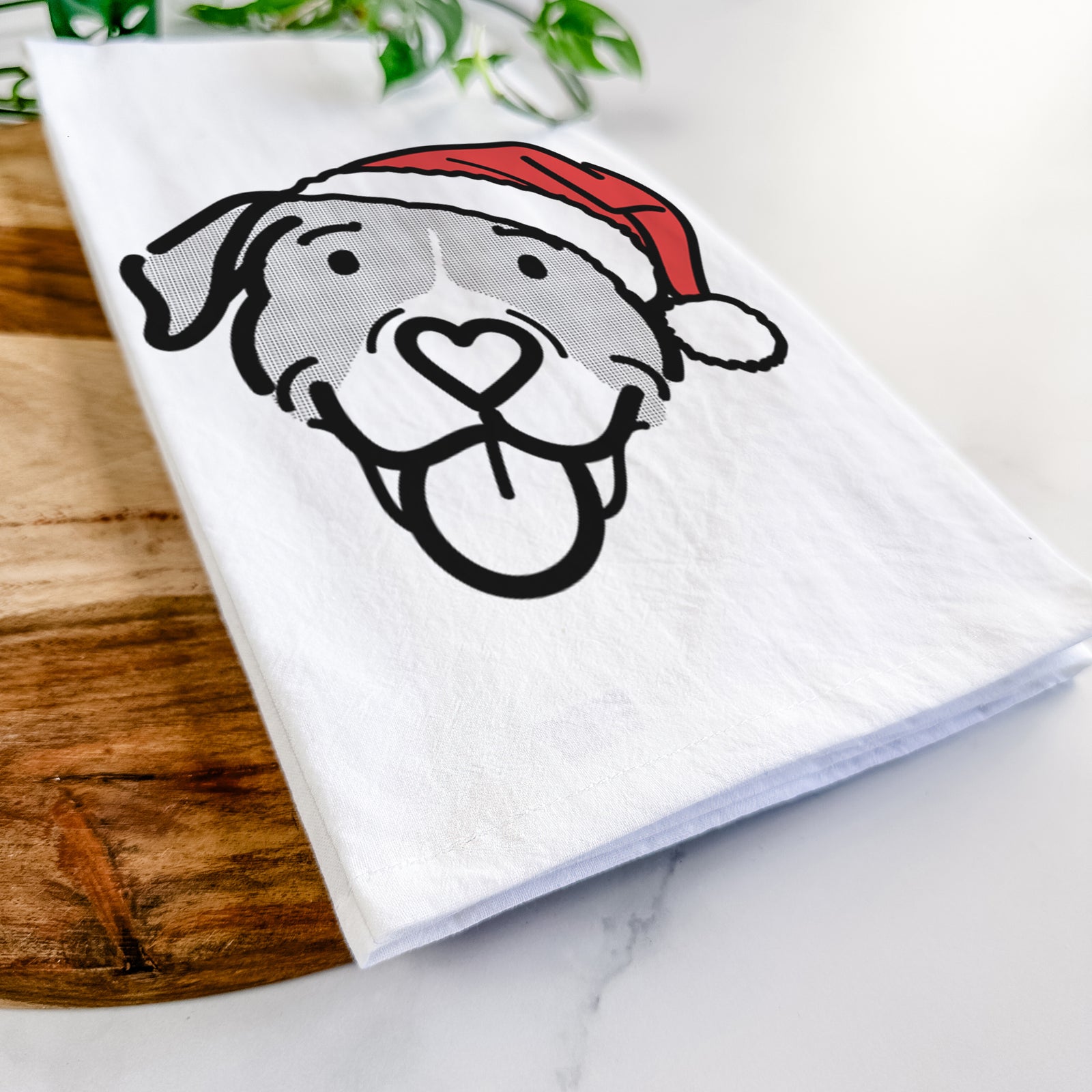 Minimalist line drawing of Shadow the Pitbull Mix wearing a Santa hat on a tea towel