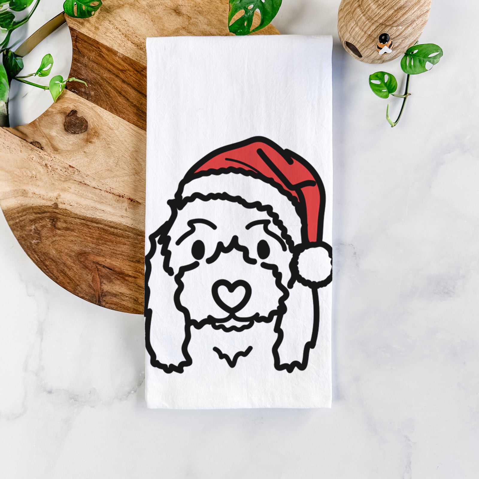Minimalist line drawing of Sophie the Coton de Tulear wearing a Santa hat on a tea towel