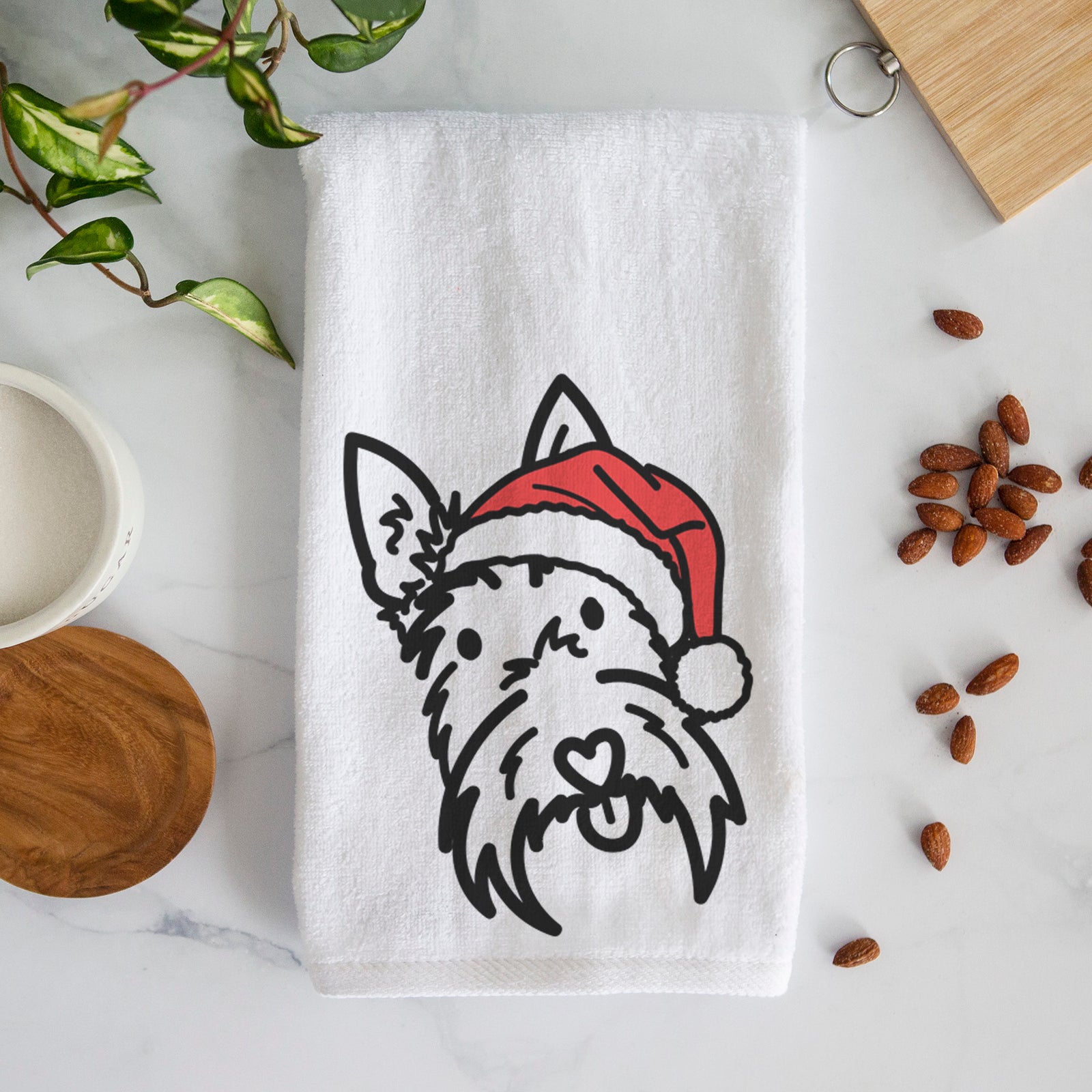 Minimalist line drawing of Thistle the Scottish Terrier wearing a Santa hat on a decorative hand towel