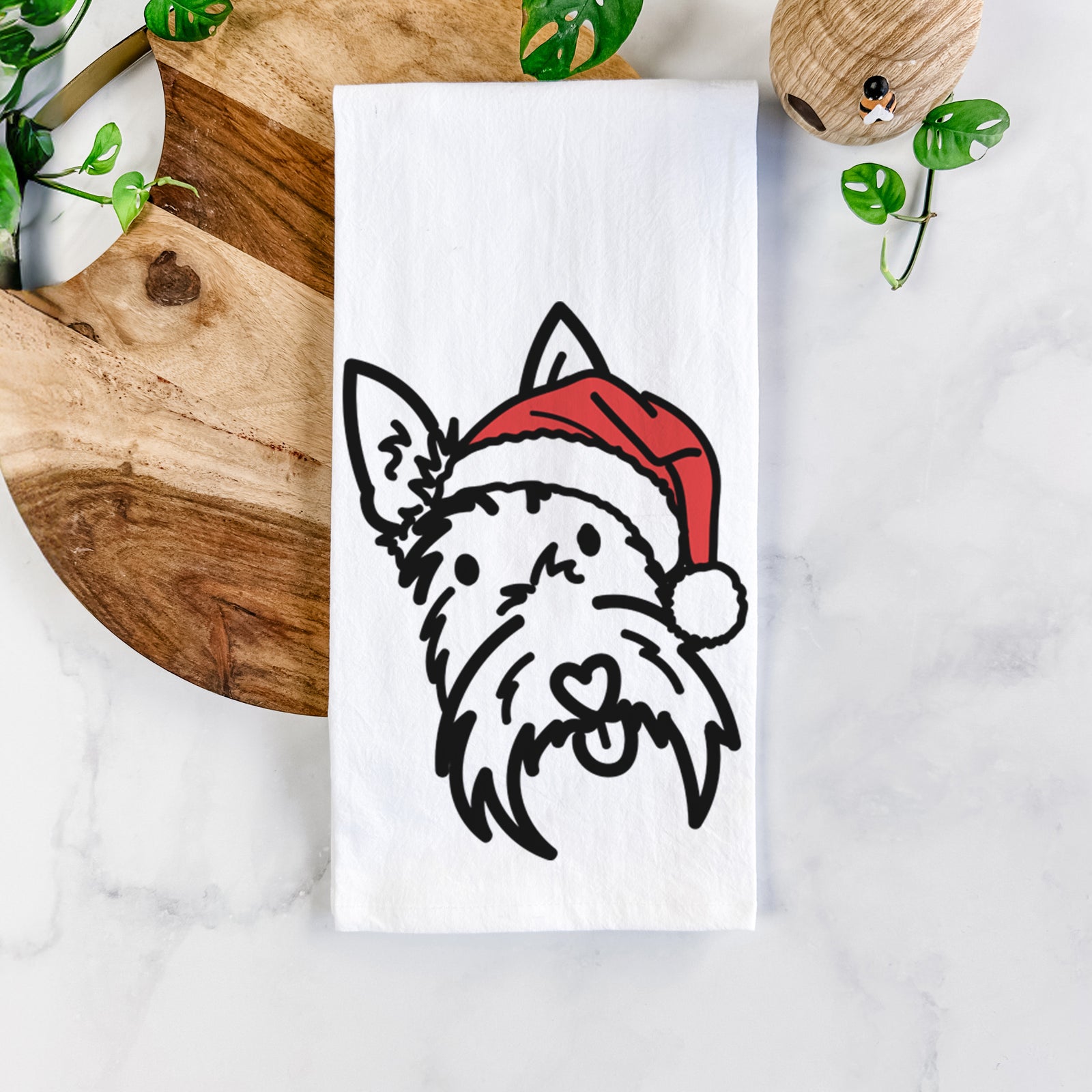 Minimalist line drawing of Thistle the Scottish Terrier wearing a Santa hat on a tea towel