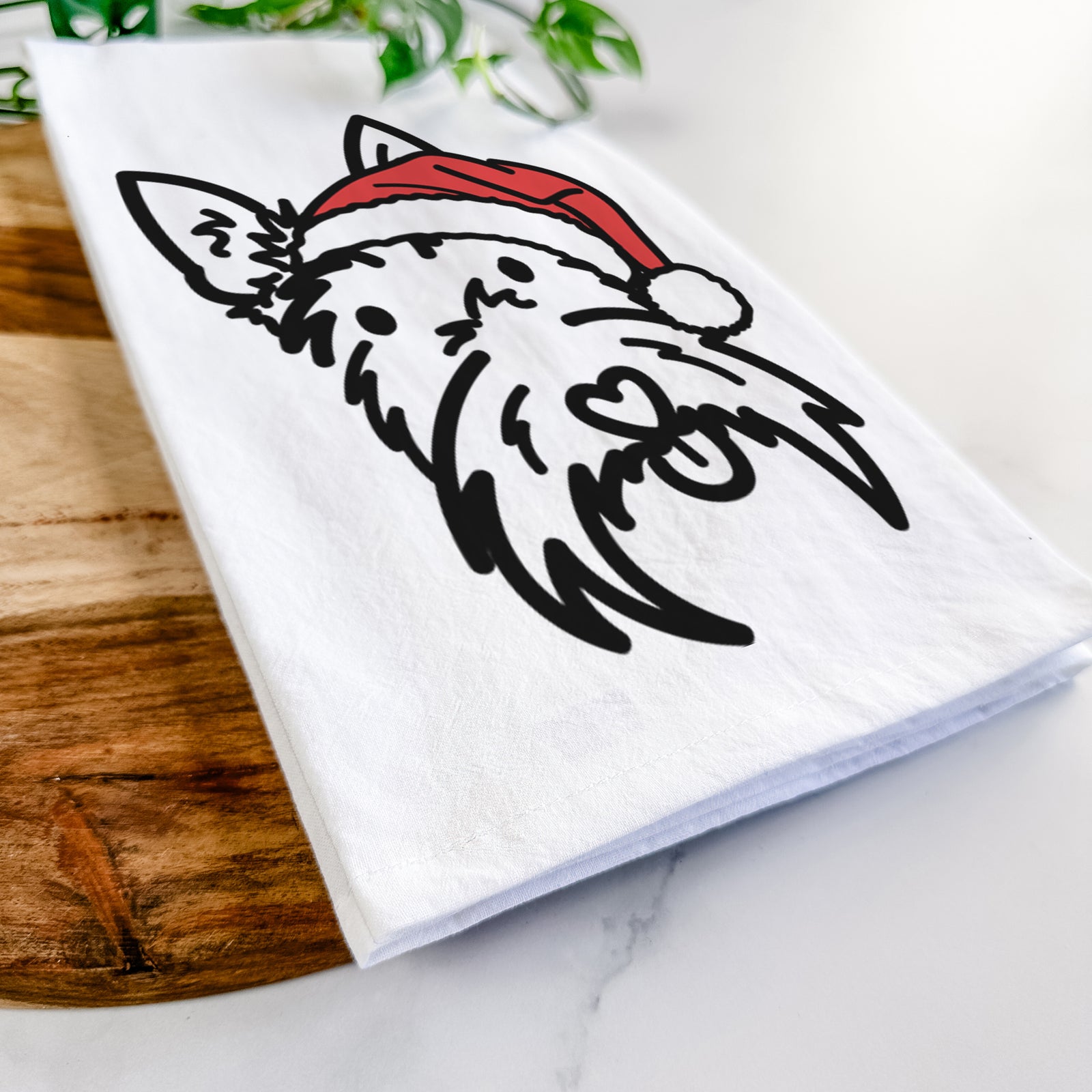 Minimalist line drawing of Thistle the Scottish Terrier wearing a Santa hat on a tea towel
