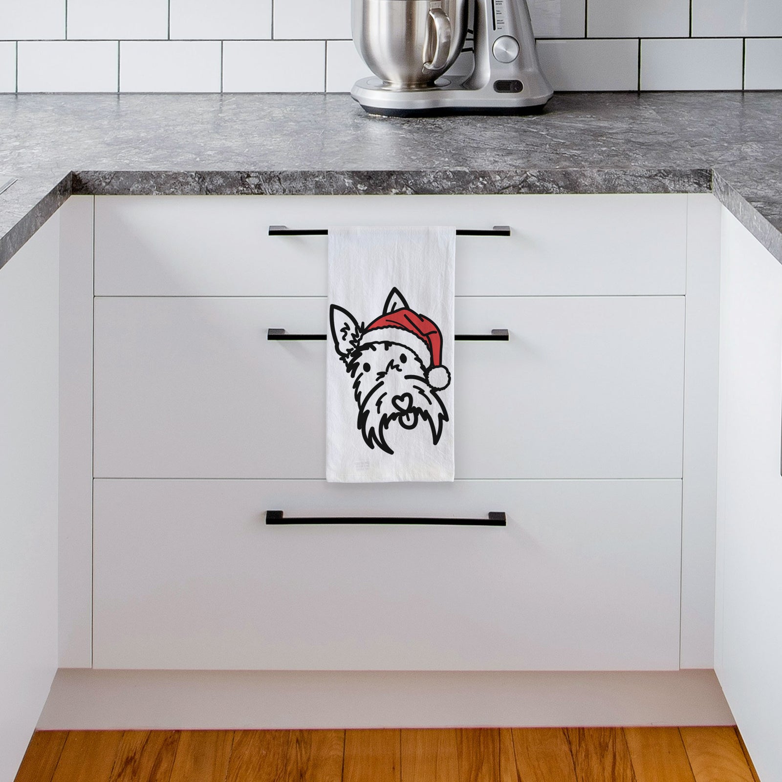 Minimalist line drawing of Thistle the Scottish Terrier wearing a Santa hat on a tea towel, hanging on an oven door in a kitchen