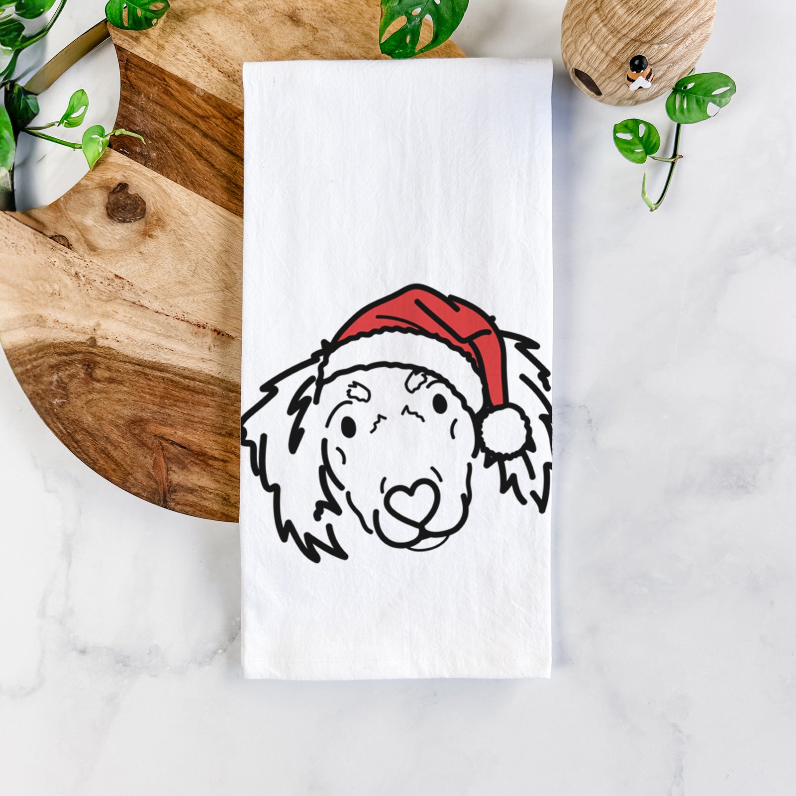 Minimalist line drawing of Tilly the Dachshund Mix wearing a Santa hat on a tea towel