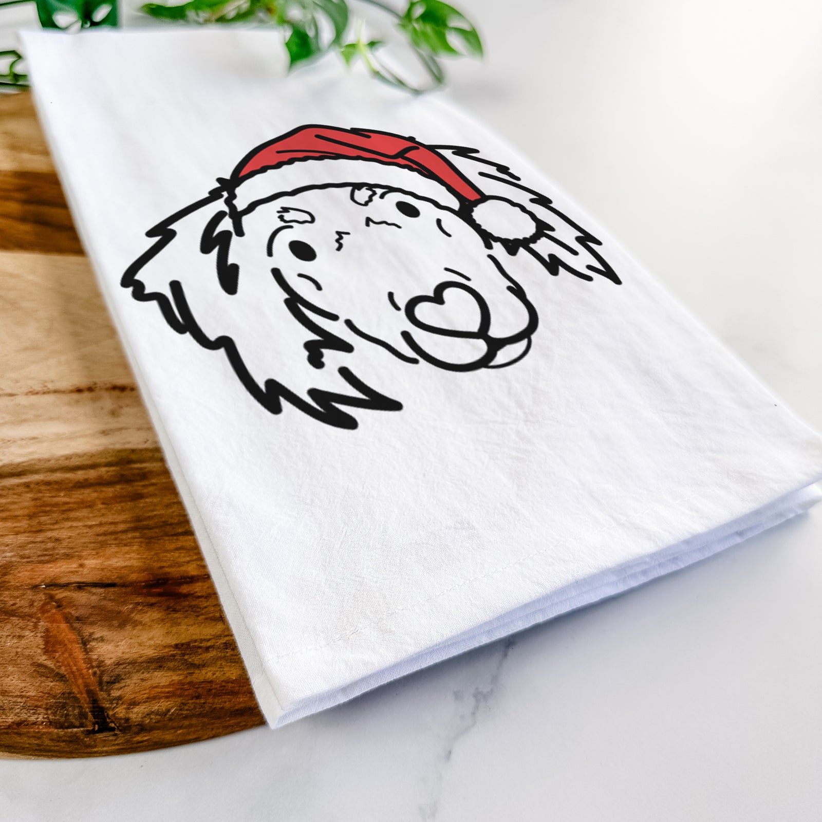 Minimalist line drawing of Tilly the Dachshund Mix wearing a Santa hat on a tea towel