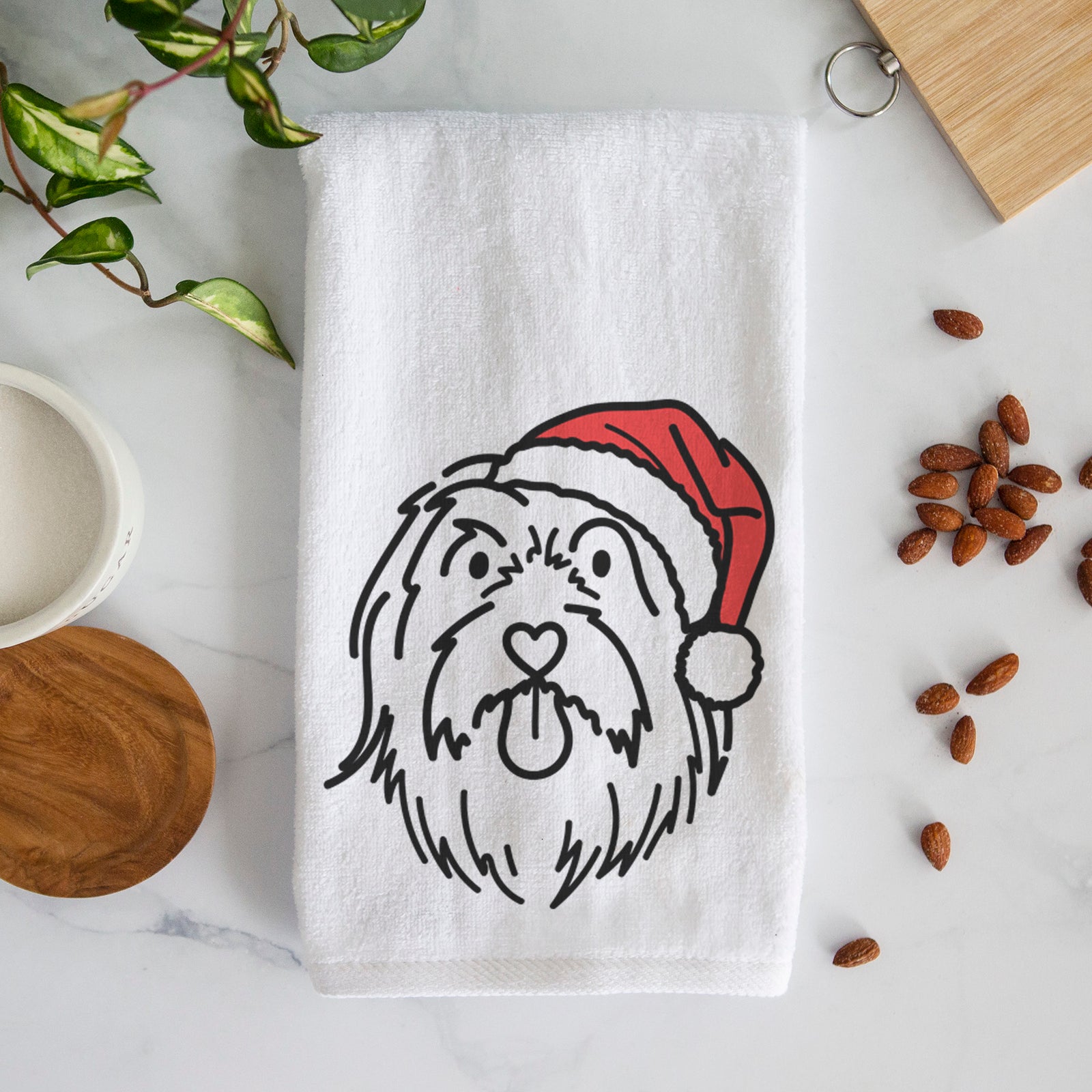 Minimalist line drawing of Tucker the Bearded Collie wearing a Santa hat on a decorative hand towel