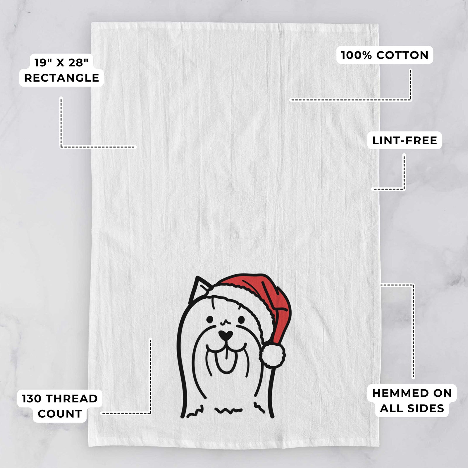 Minimalist line drawing of a Yorkshire Terrier wearing a Santa hat on a tea towel, with feature callouts: 19 x 28 inch rectangle, 100% cotton, lint-free, 120 thread count, hemmed on all sides