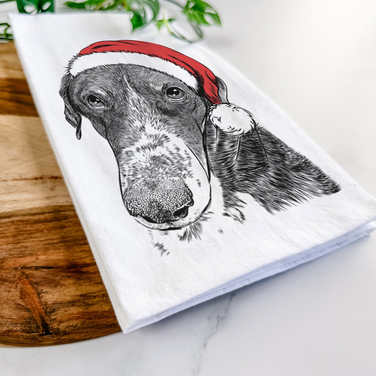 Hand-drawn sketch of Angel Orion the Mixed Breed wearing a Santa hat on a tea towel