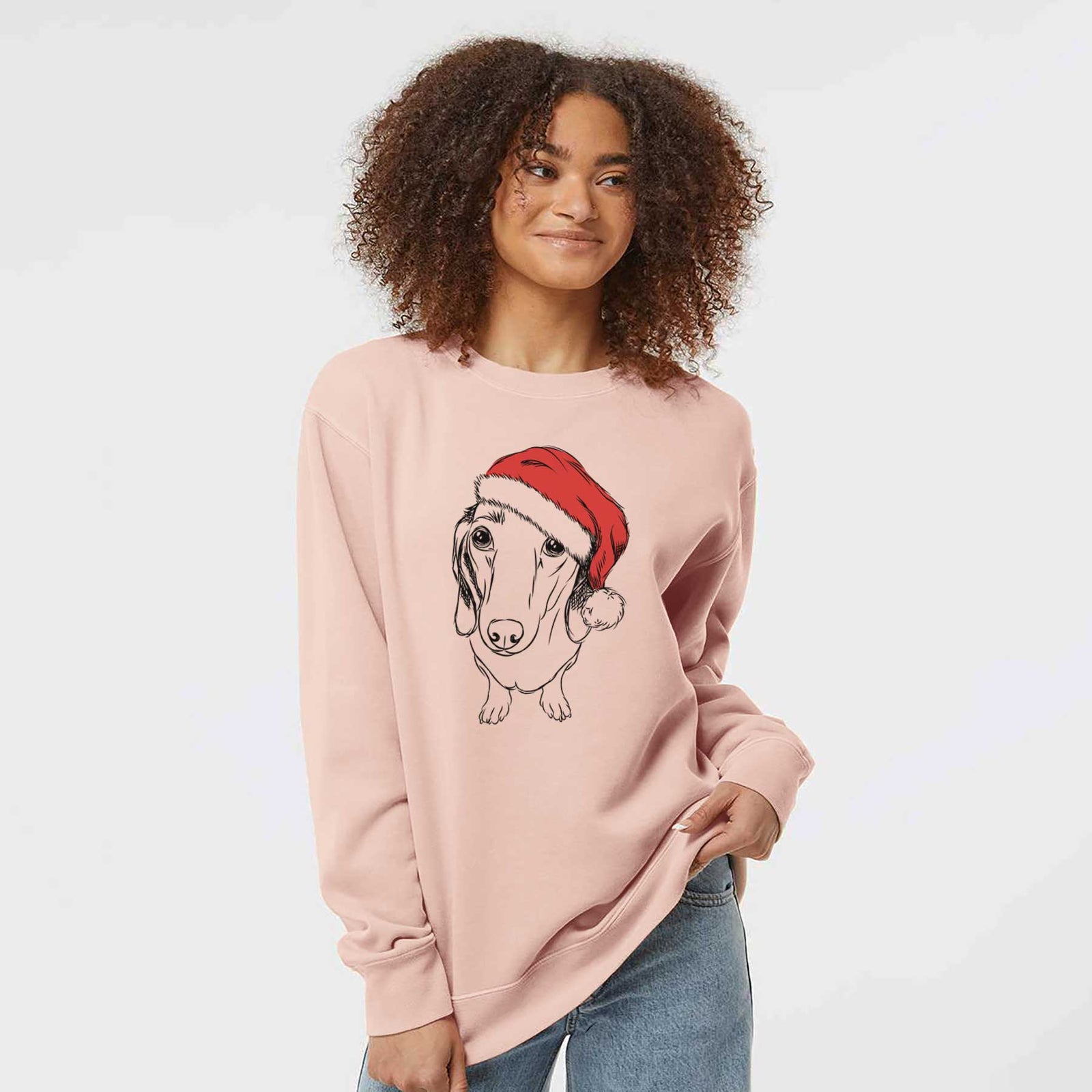 Hand-drawn sketch of Annabelle the Dachshund wearing a Santa hat on a Dusty Pink Unisex pigment dyed crew sweatshirt