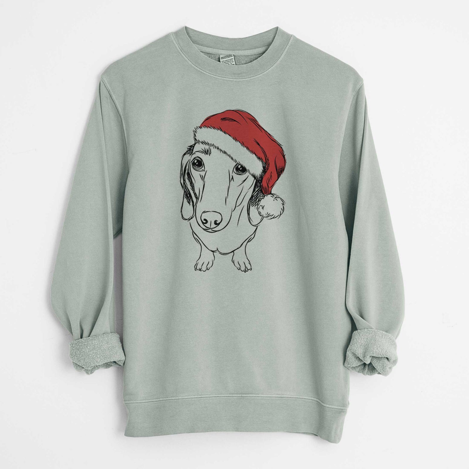 Hand-drawn sketch of Annabelle the Dachshund wearing a Santa hat on a Sage Unisex pigment dyed crew sweatshirt