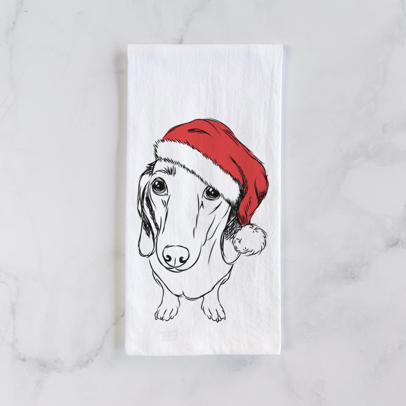 Hand-drawn sketch of Annabelle the Dachshund wearing a Santa hat on a tea towel