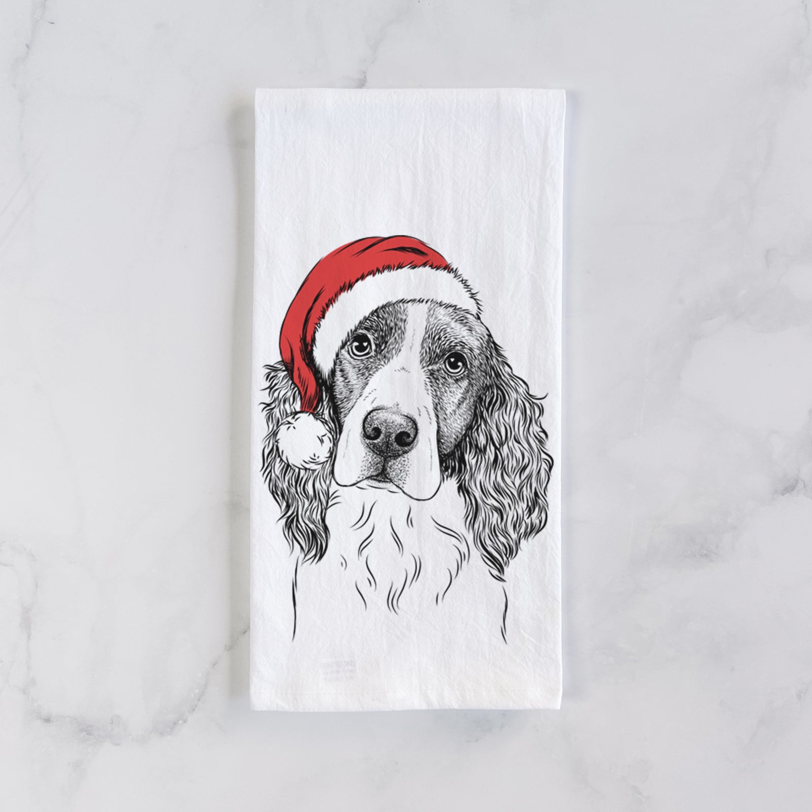 Hand-drawn sketch of Annie the English Springer Spaniel wearing a Santa hat on a tea towel