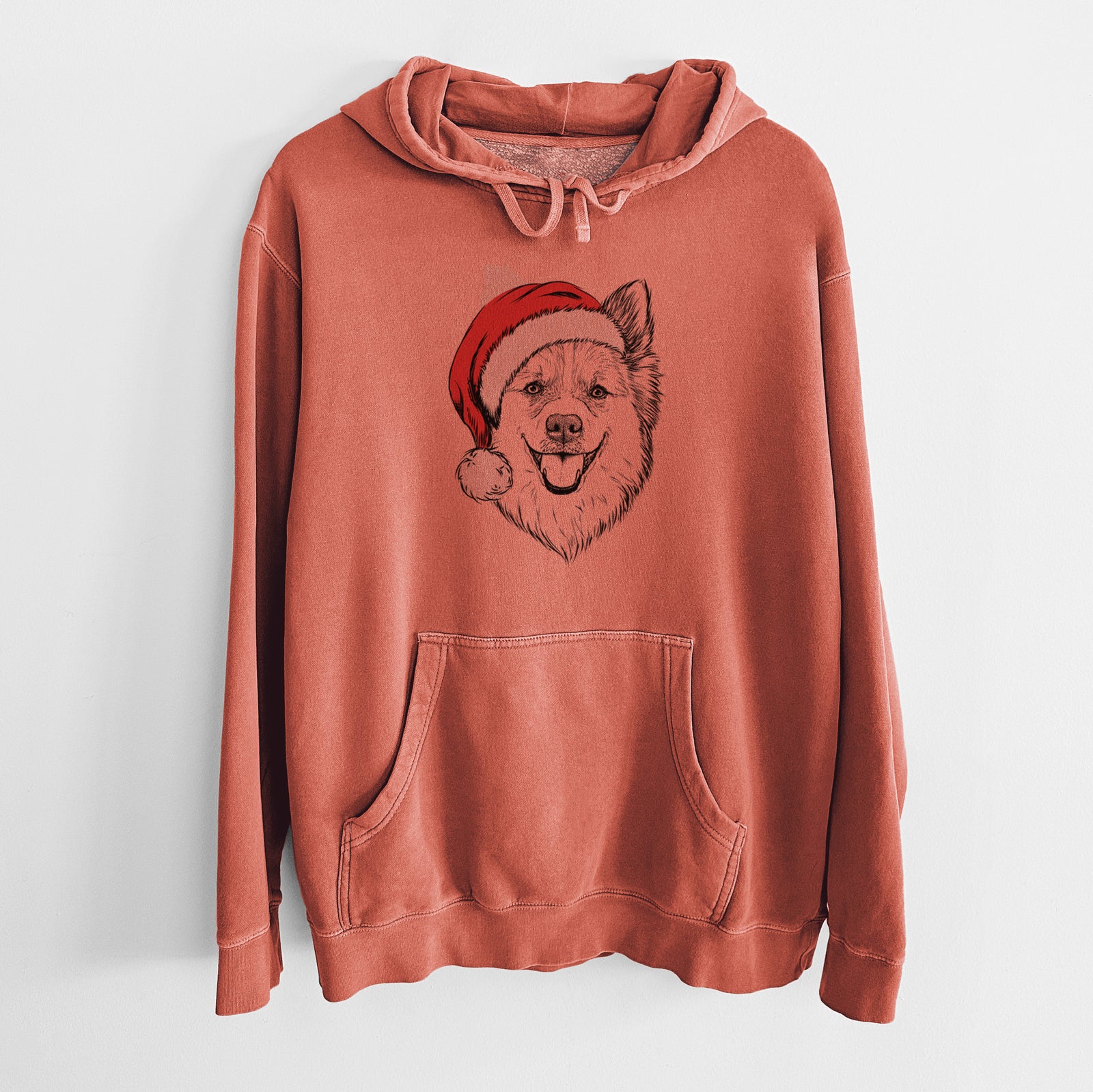 Hand-drawn sketch of Ari the Icelandic Sheepdog wearing a Santa hat on an Amber Unisex pigment dyed hoodie