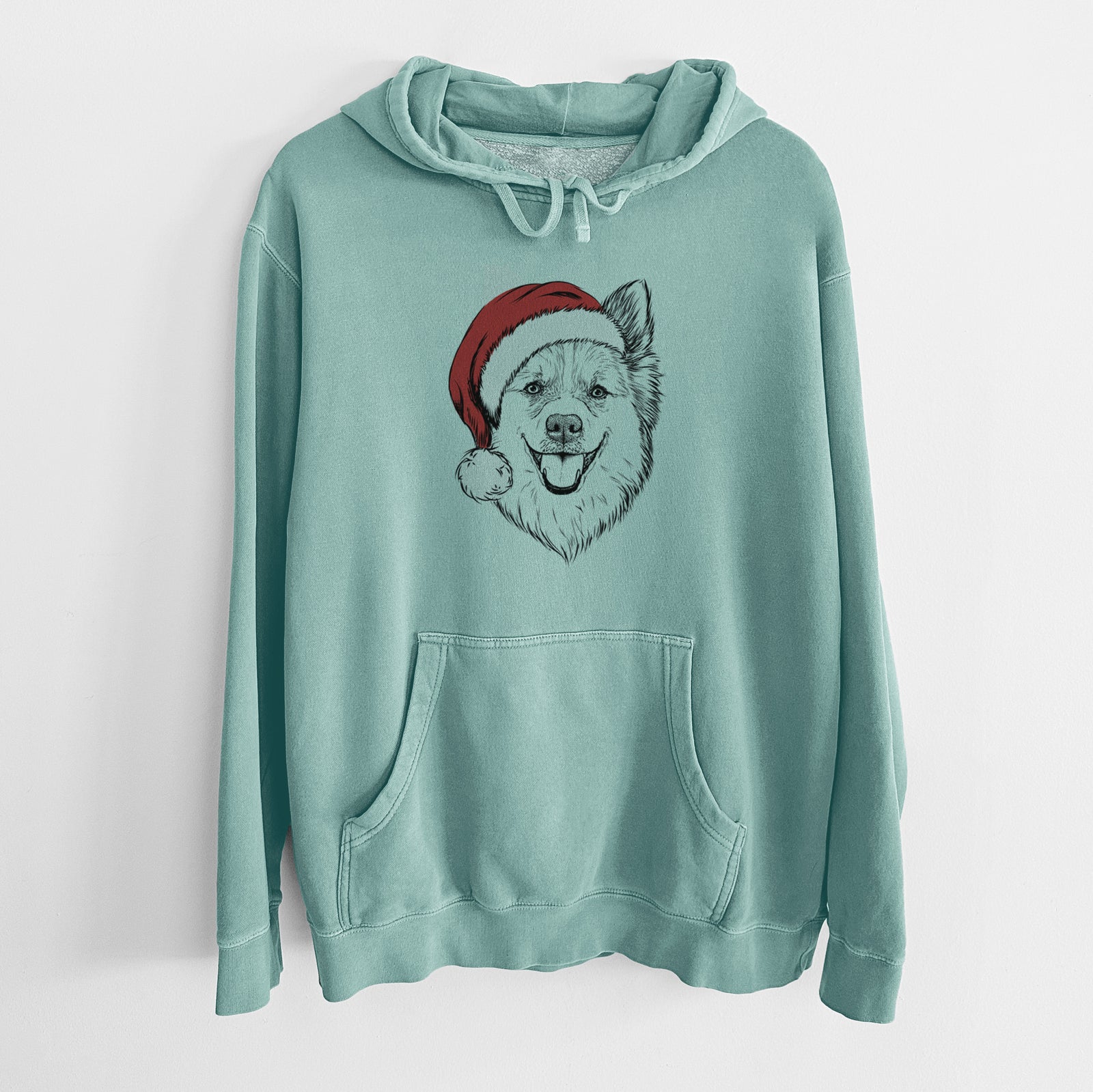 Hand-drawn sketch of Ari the Icelandic Sheepdog wearing a Santa hat on a Mint Unisex pigment dyed hoodie
