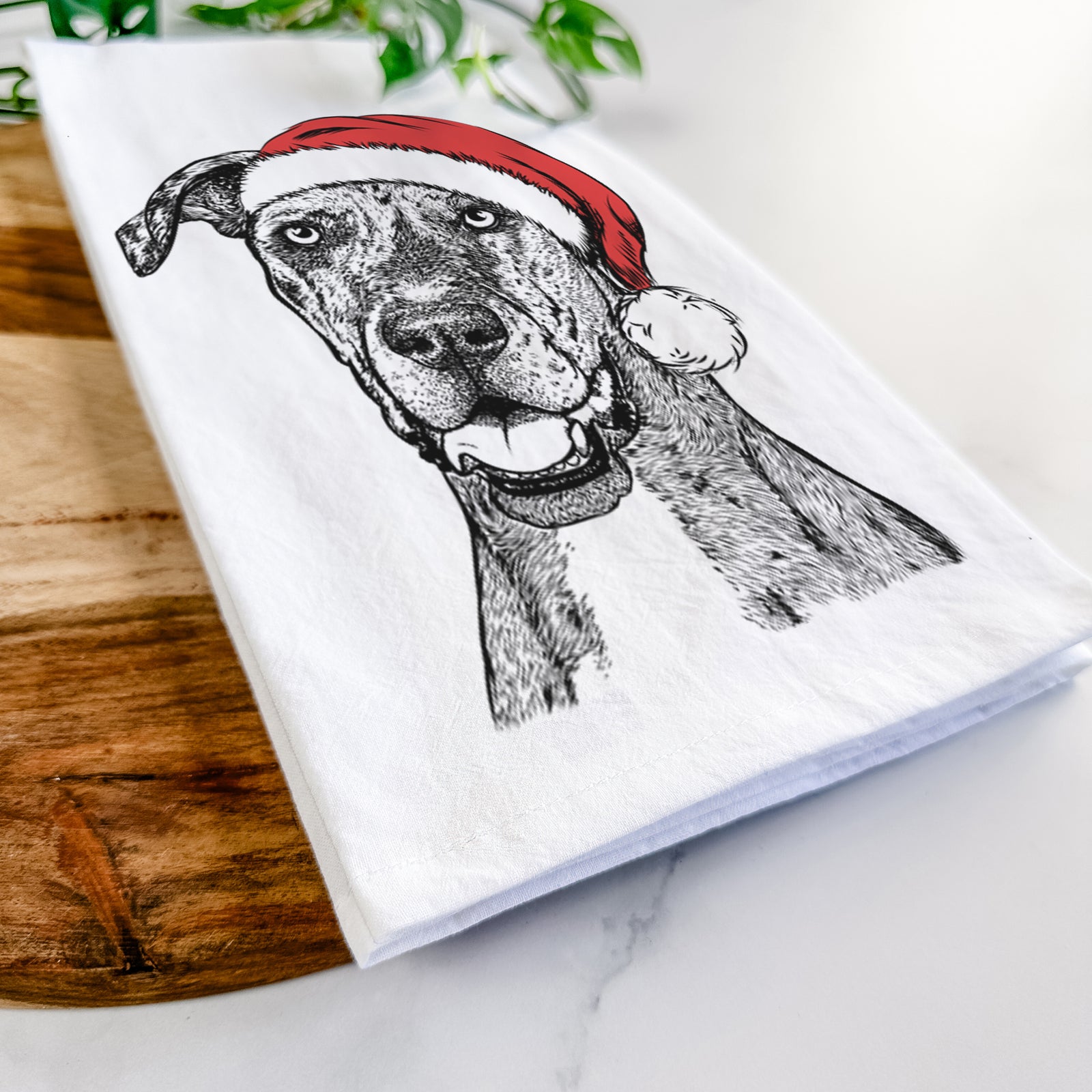 Hand-drawn sketch of Athena the Merle Great Dane wearing a Santa hat on a tea towel