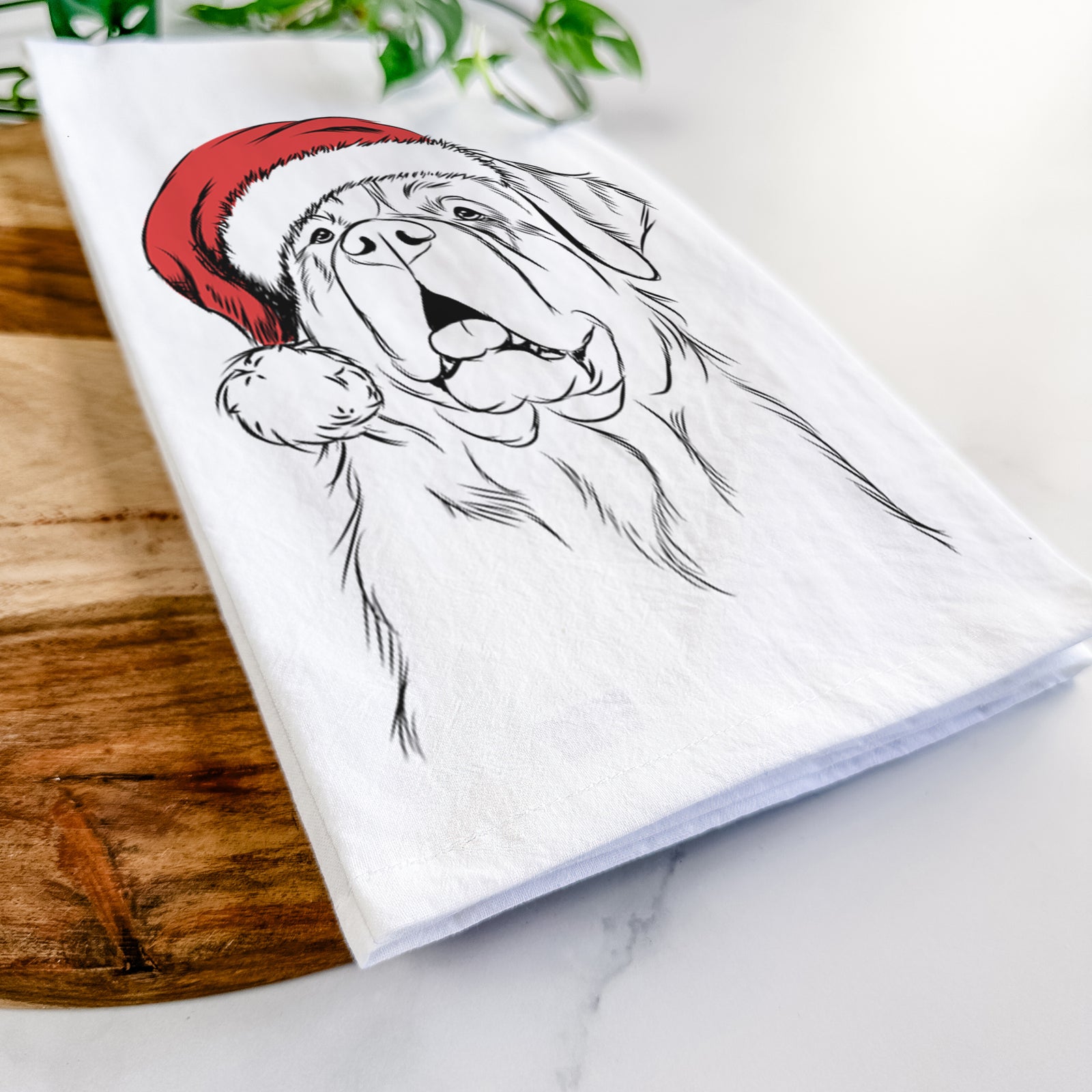 Hand-drawn sketch of Atlas the Saint Bernard wearing a Santa hat on a tea towel