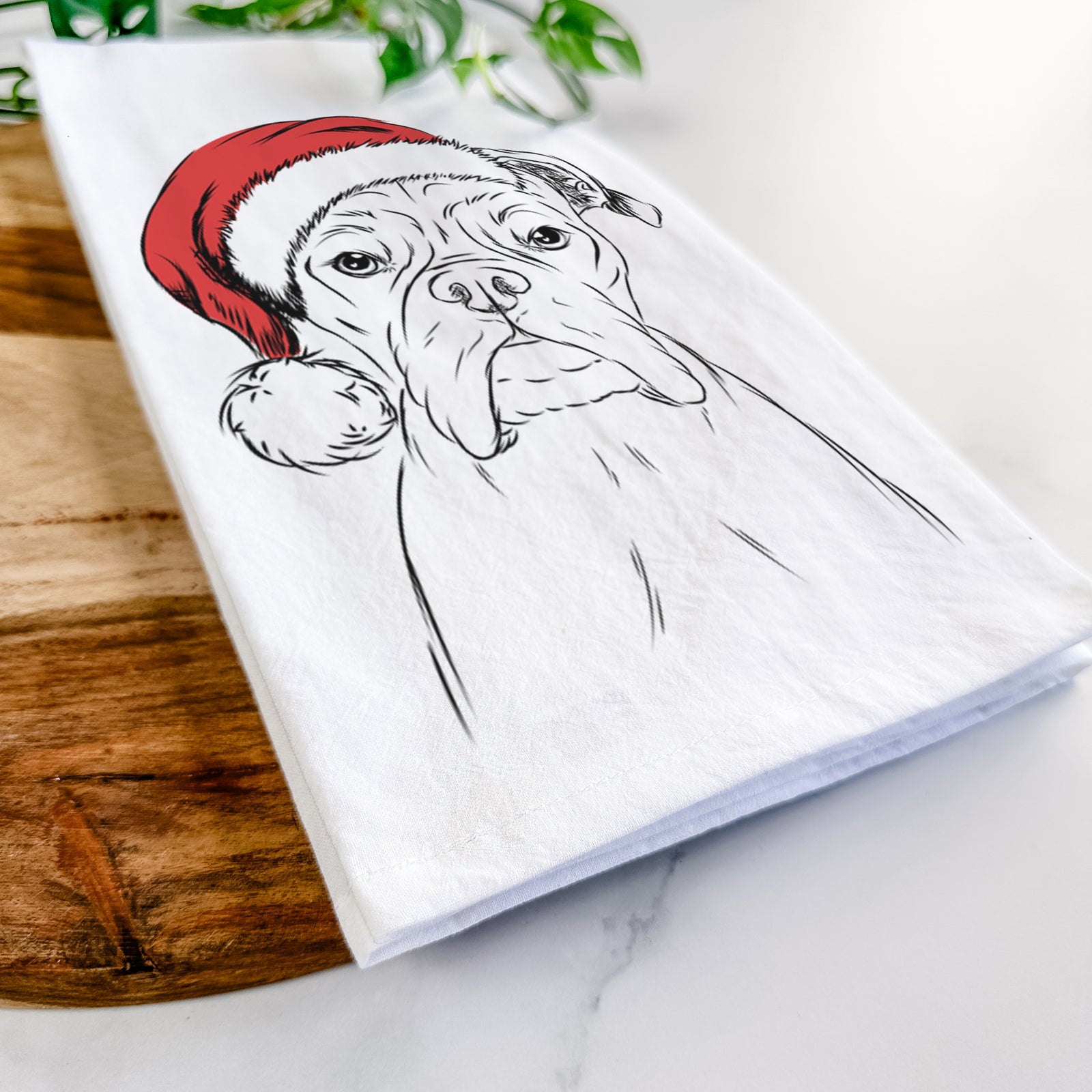 Hand-drawn sketch of Axel the Boxer wearing a Santa hat on a tea towel