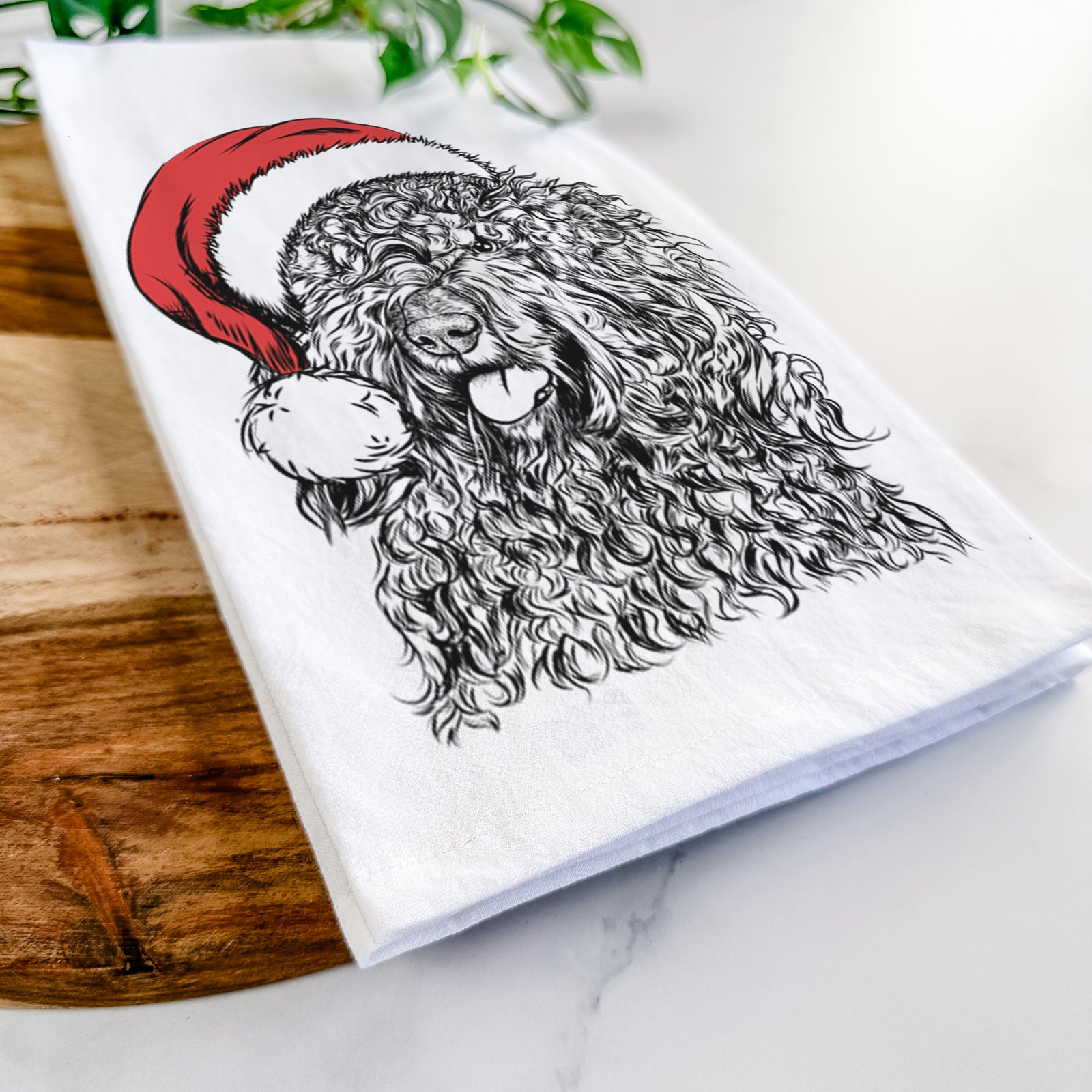 Hand-drawn sketch of Babs the Barbet wearing a Santa hat on a tea towel