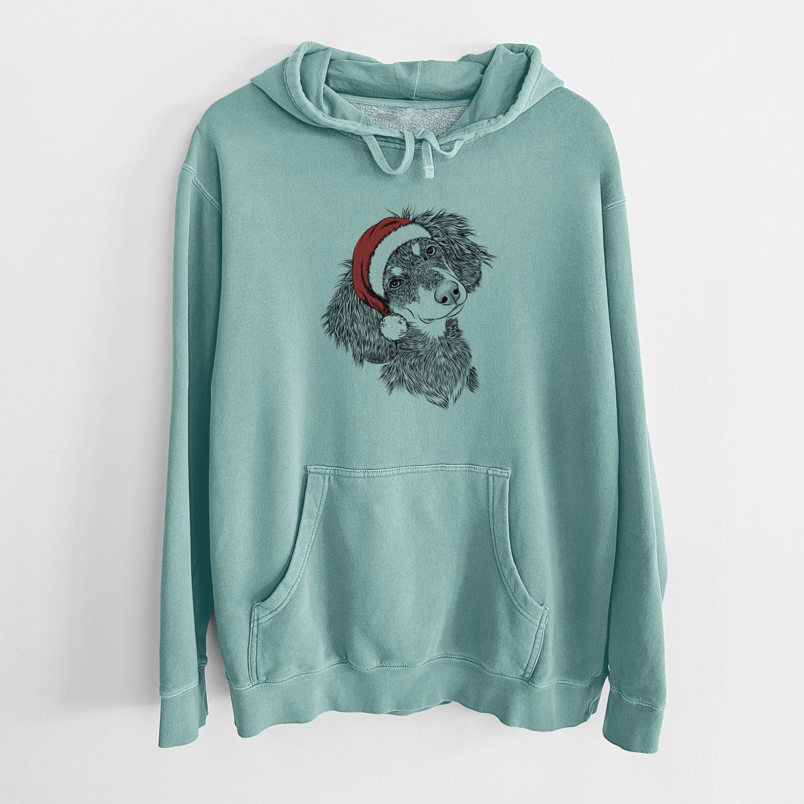 Hand-drawn sketch of Bailey the Long Haired Dachshund wearing a Santa hat on a Mint Unisex pigment dyed hoodie