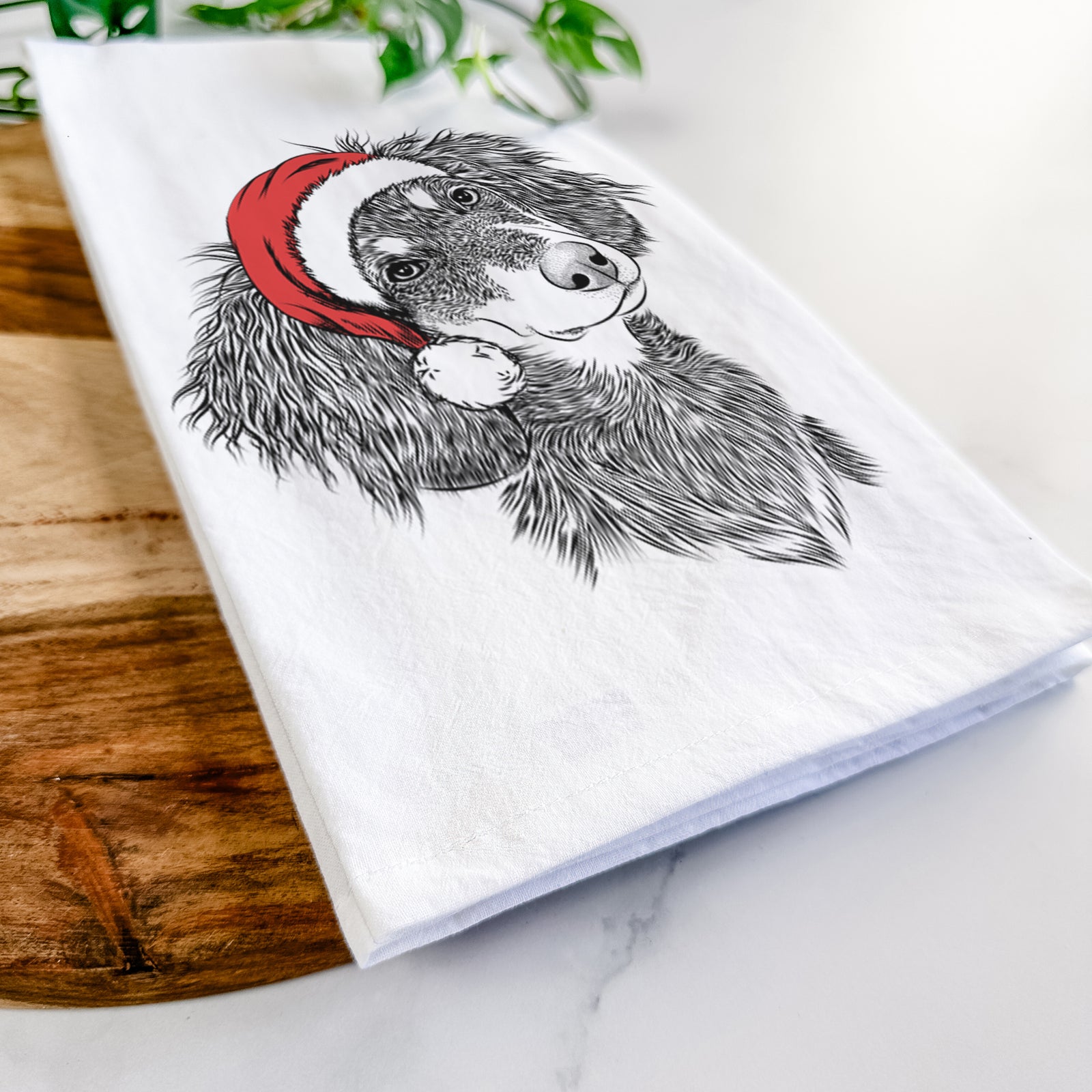 Hand-drawn sketch of Bailey the Long Haired Dachshund wearing a Santa hat on a tea towel