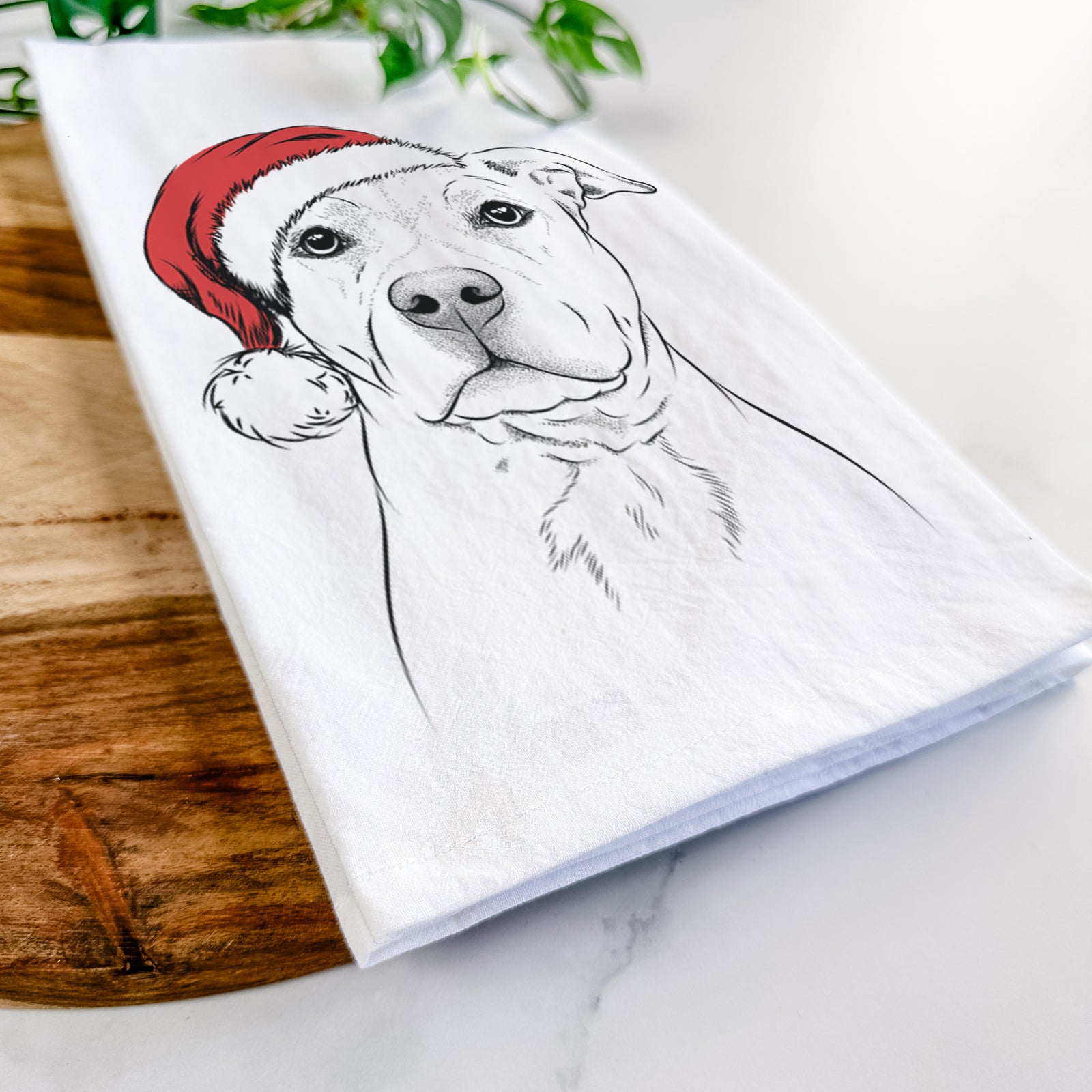 Hand-drawn sketch of Bailey the American Staffordshire Terrier wearing a Santa hat on a tea towel