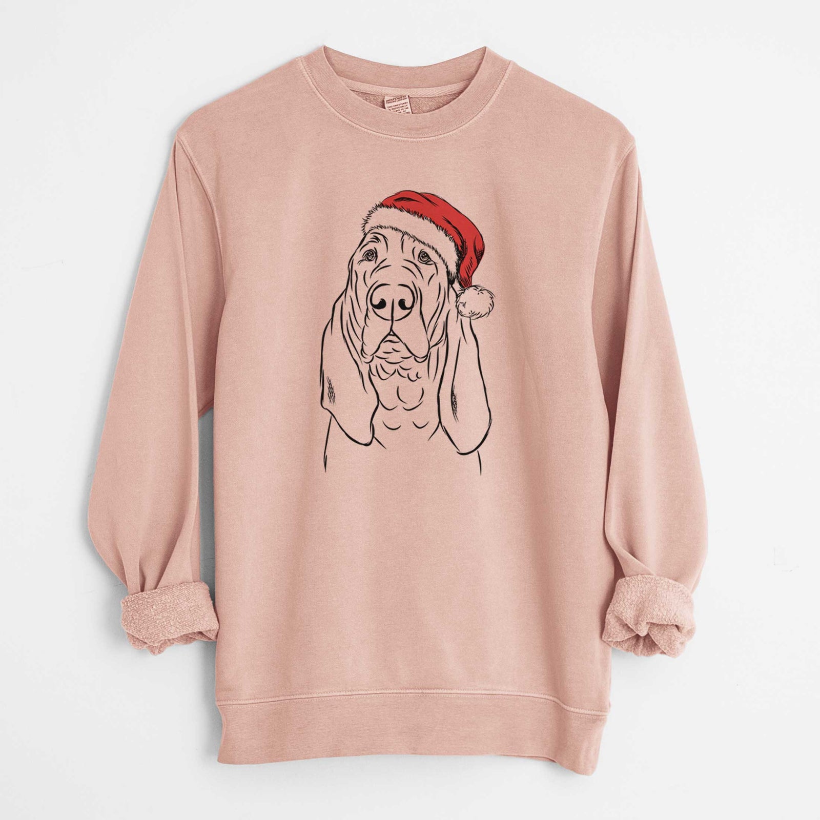Hand-drawn sketch of Baron the Bloodhound wearing a Santa hat on a Dusty Pink Unisex pigment dyed crew sweatshirt
