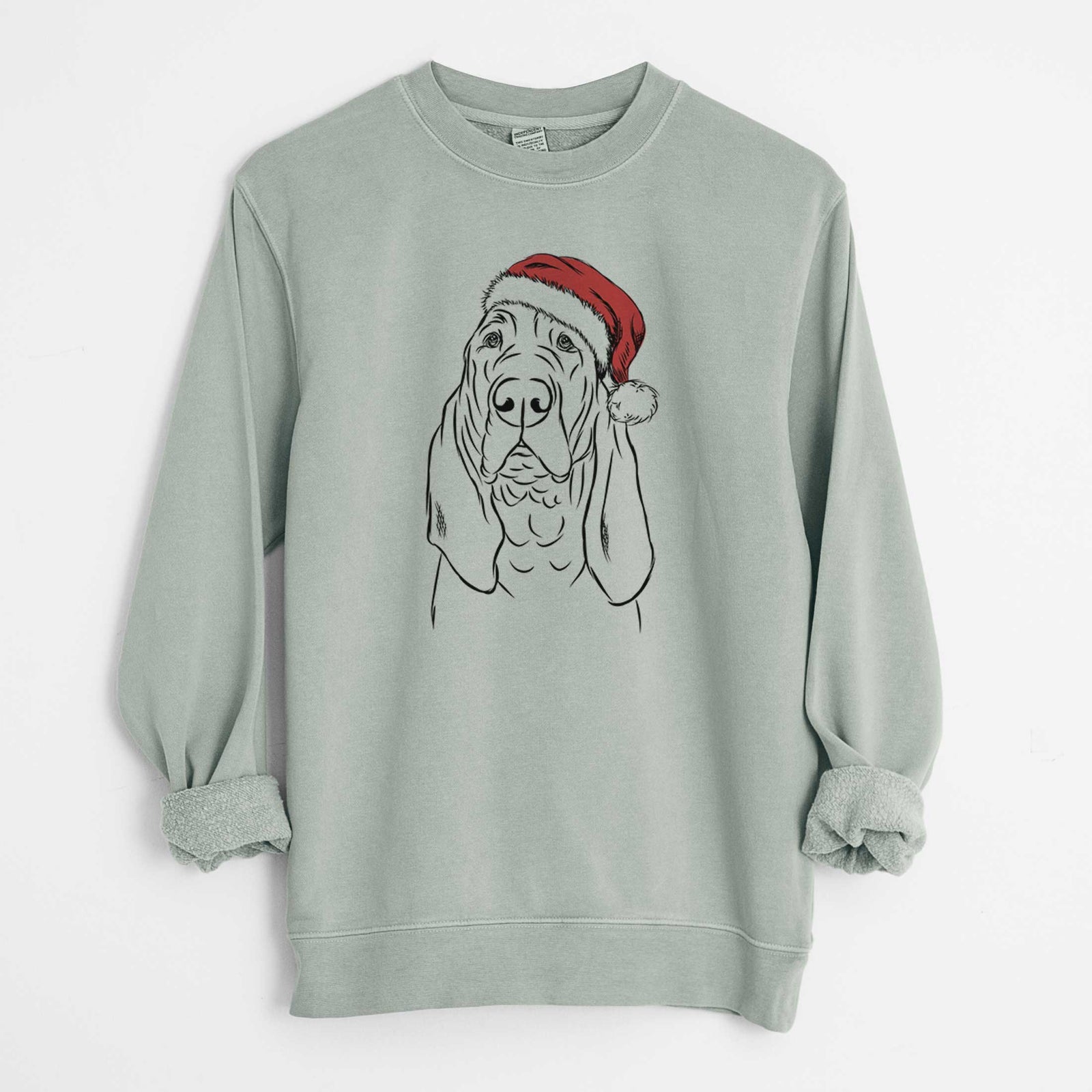 Hand-drawn sketch of Baron the Bloodhound wearing a Santa hat on a Sage Unisex pigment dyed crew sweatshirt