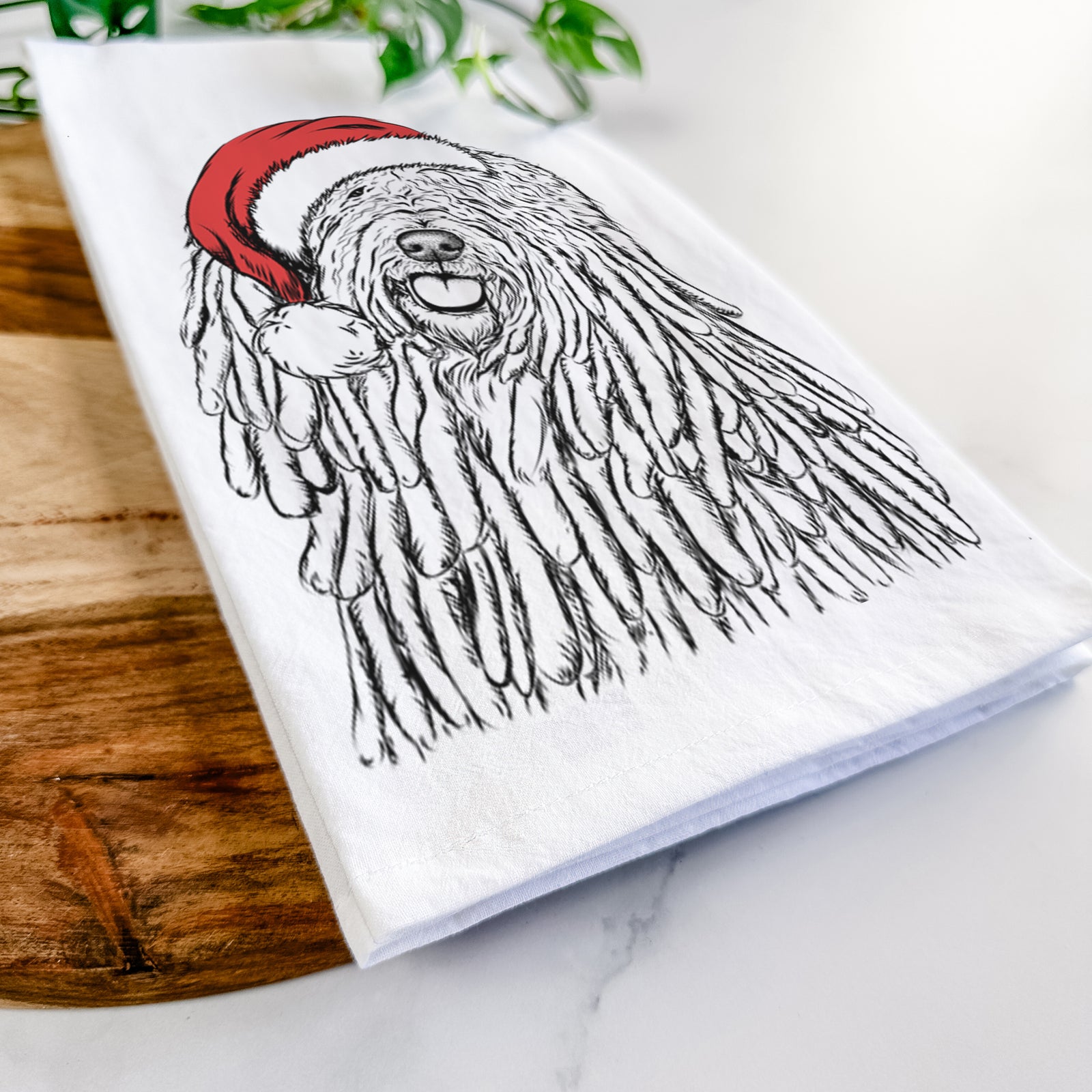 Hand-drawn sketch of Barry the Komondor wearing a Santa hat on a tea towel