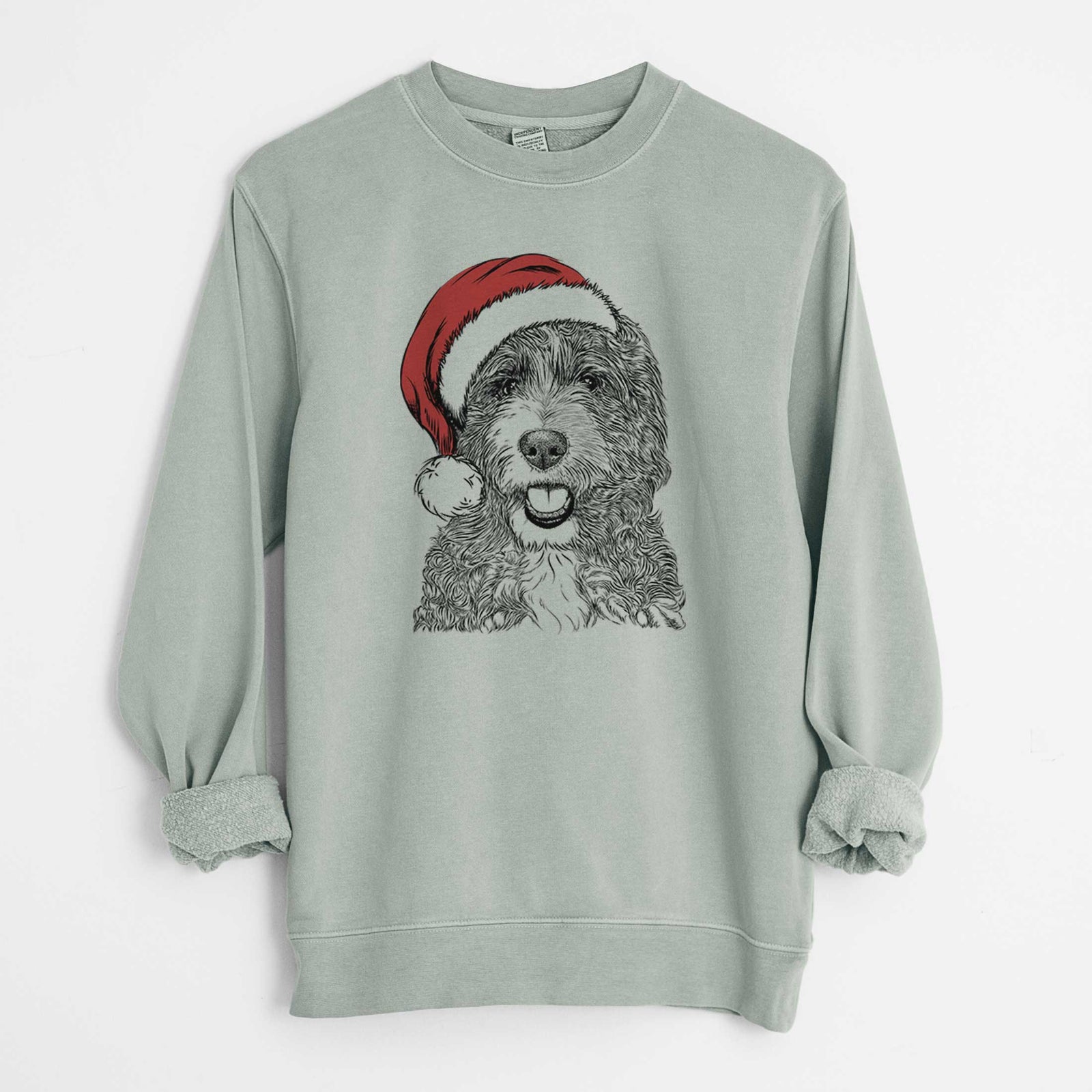 Hand-drawn sketch of Bash the Bernedoodle wearing a Santa hat on a Sage Unisex pigment dyed crew sweatshirt