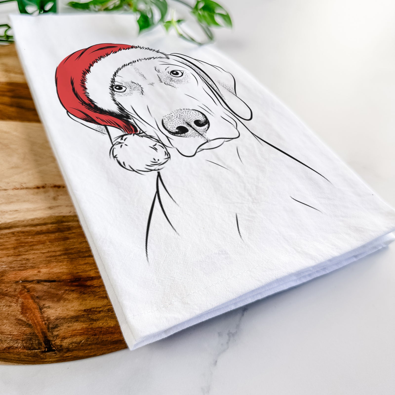 Hand-drawn sketch of Benelli the Vizsla wearing a Santa hat on a tea towel