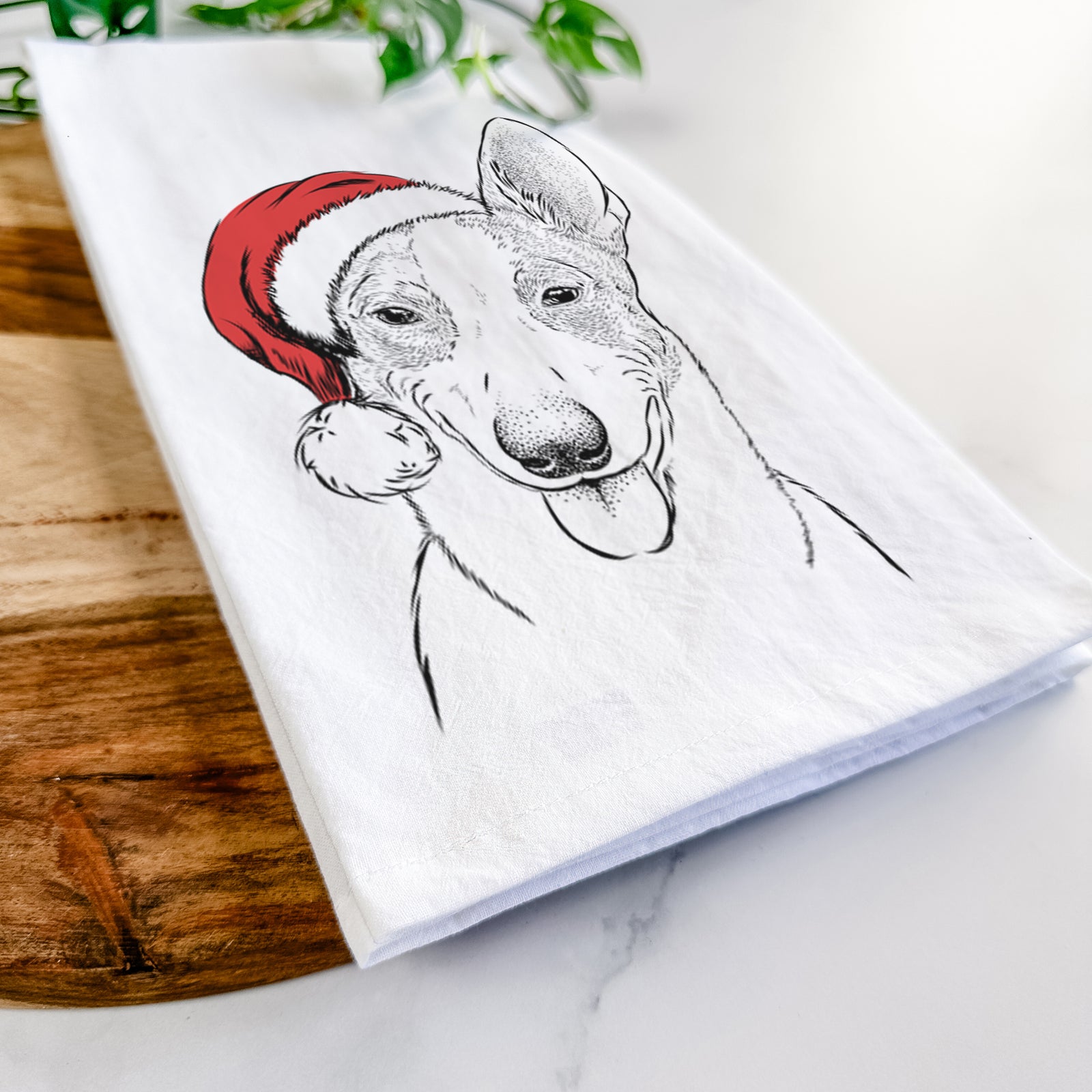 Hand-drawn sketch of Berlin the Carolina Dog wearing a Santa hat on a tea towel