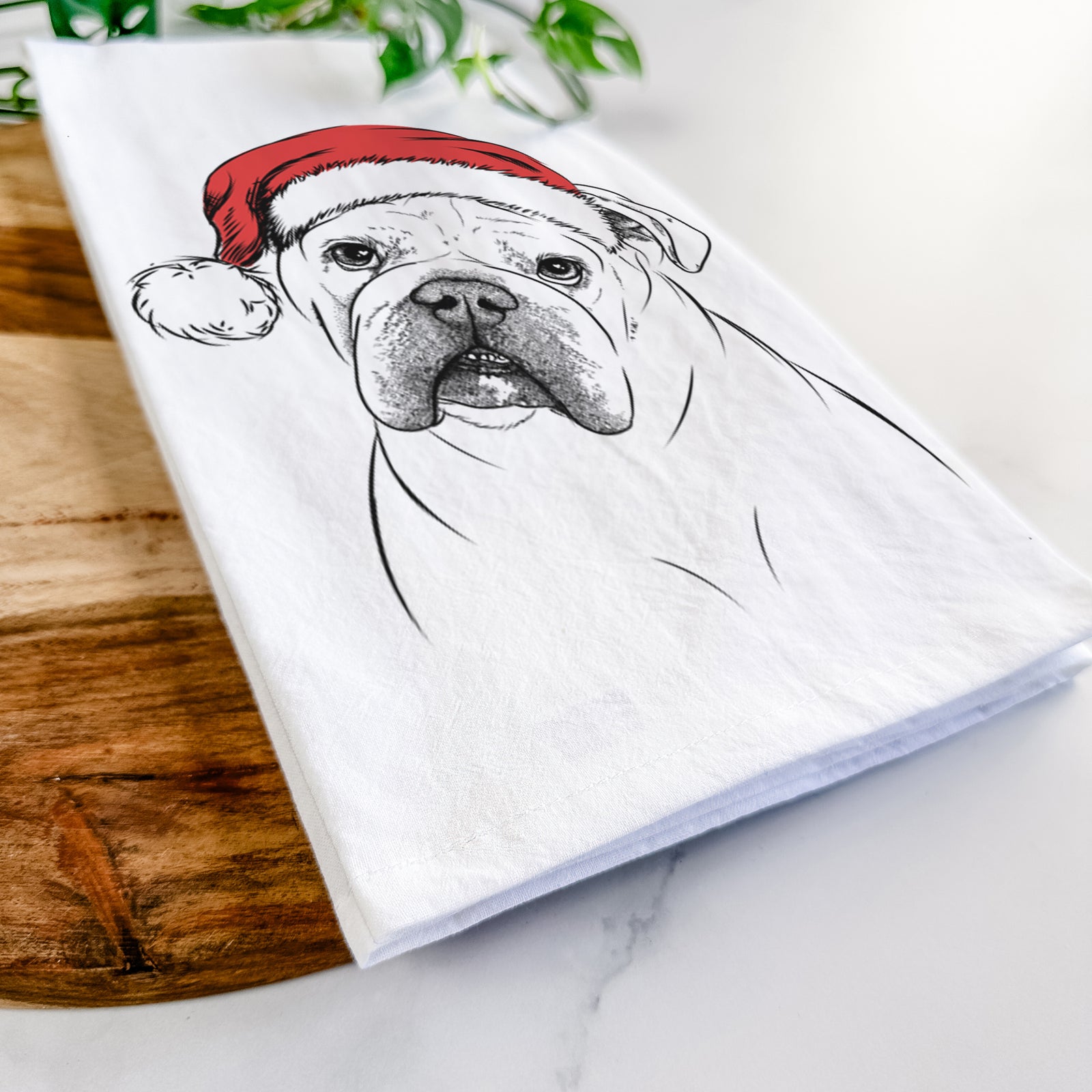 Hand-drawn sketch of Blossom the English Bulldog wearing a Santa hat on a tea towel