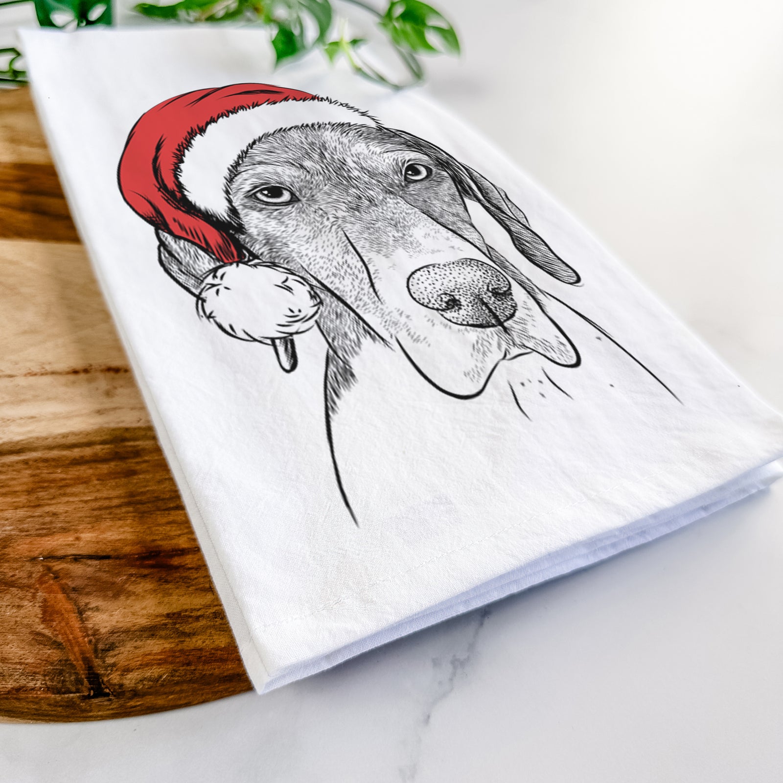 Hand-drawn sketch of Bohdi the German Shorthaired Pointer wearing a Santa hat on a tea towel