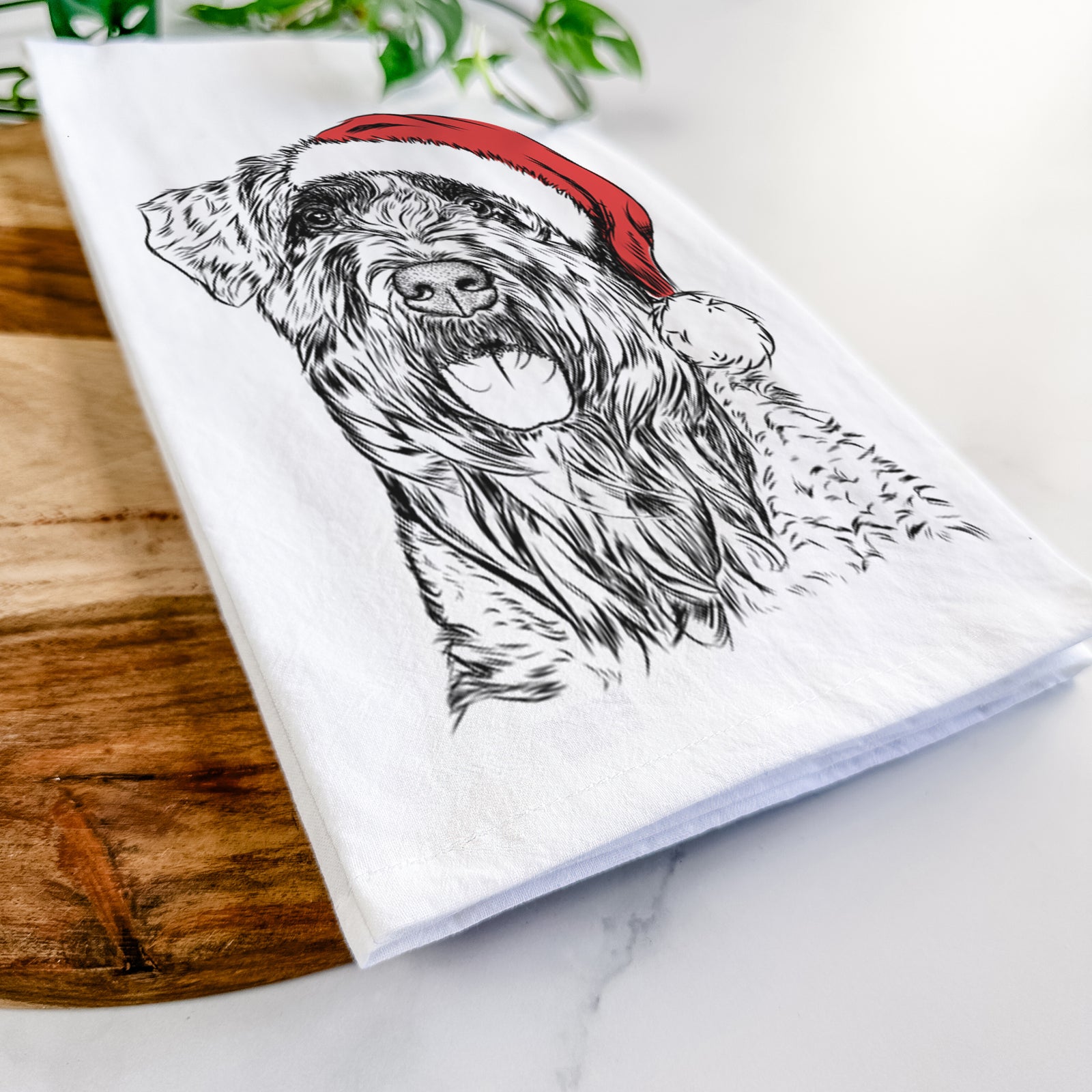 Hand-drawn sketch of Bonnie the Bouvier Des Flandres wearing a Santa hat on a tea towel