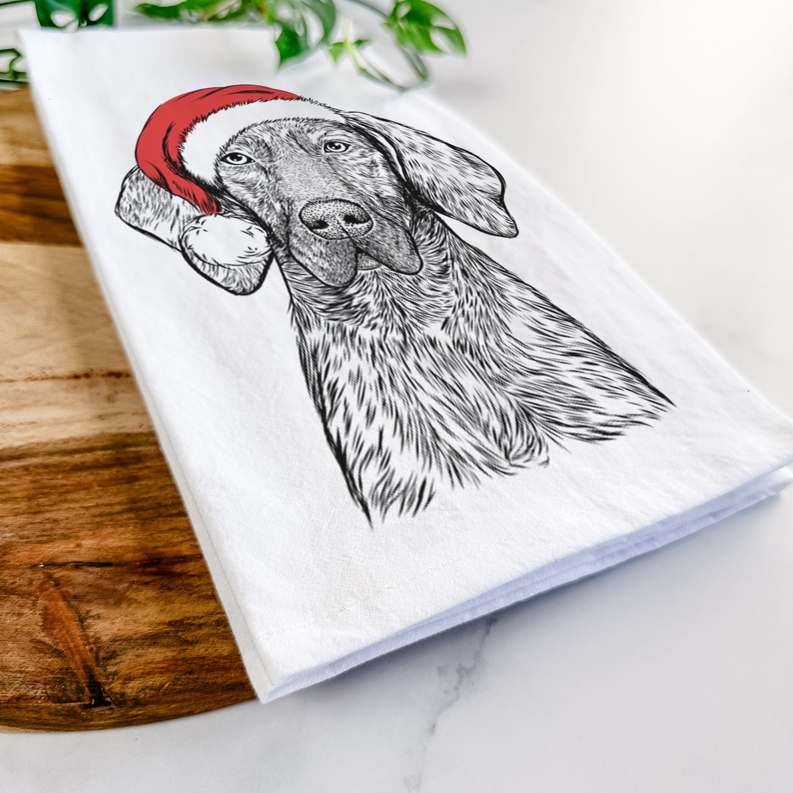 Hand-drawn sketch of Boone the Plott Hound wearing a Santa hat on a tea towel