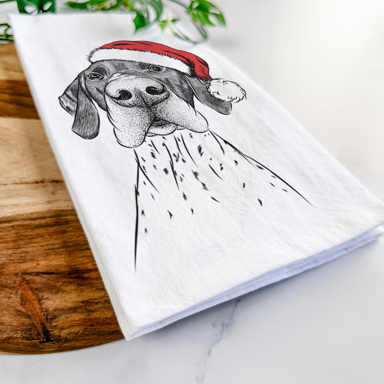 Hand-drawn sketch of Booze the German Shorthaired Pointer wearing a Santa hat on a tea towel