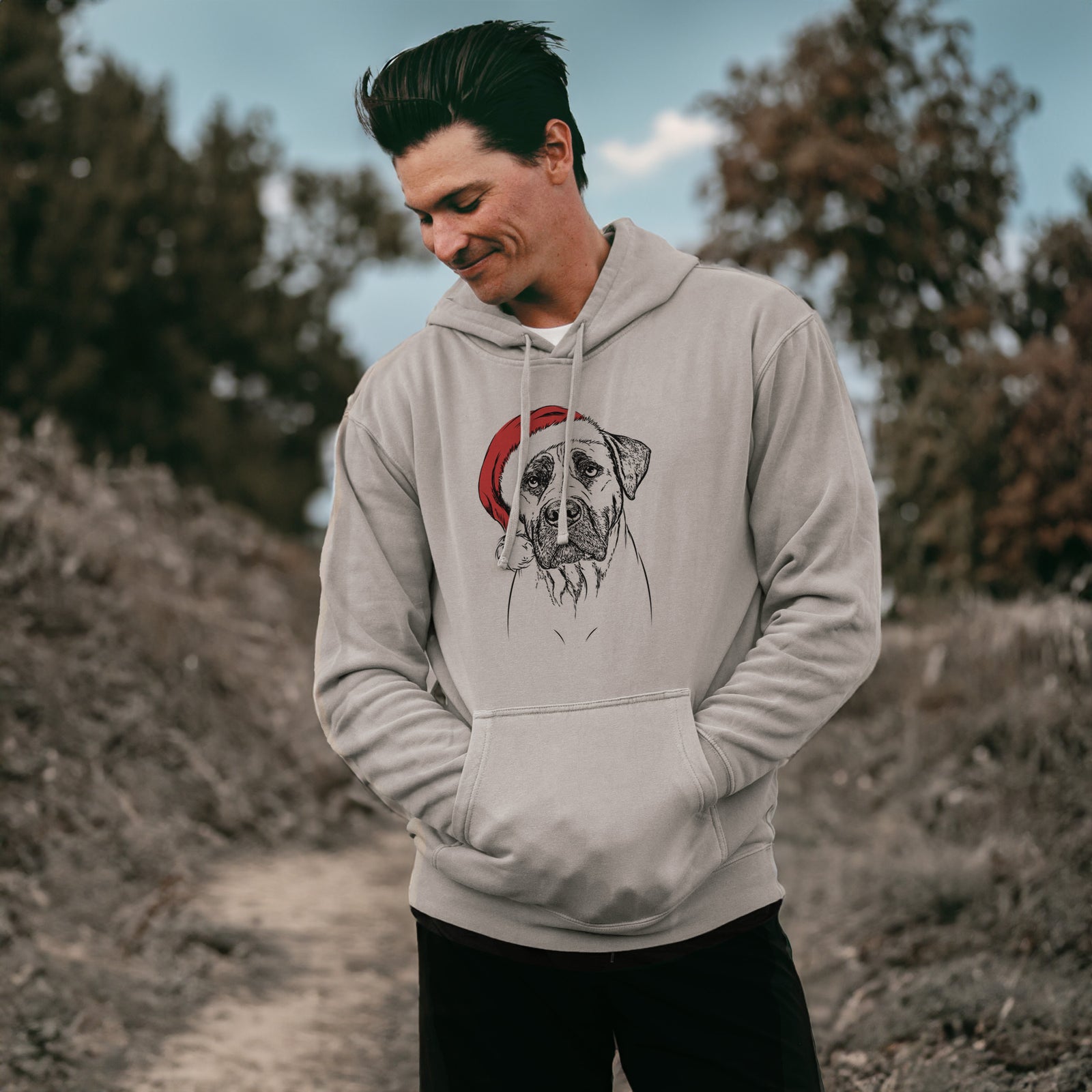 Hand-drawn sketch of Boris the Boerboel wearing a Santa hat on a Cement Unisex pigment dyed hoodie, worn by a man
