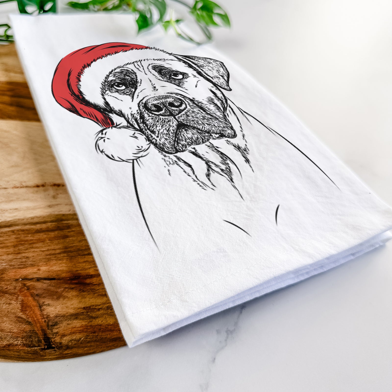 Hand-drawn sketch of Boris the Boerboel wearing a Santa hat on a tea towel
