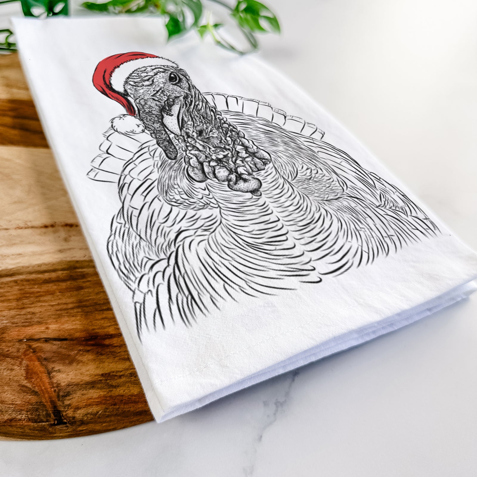 Hand-drawn sketch of Brady the Turkey wearing a Santa hat on a tea towel