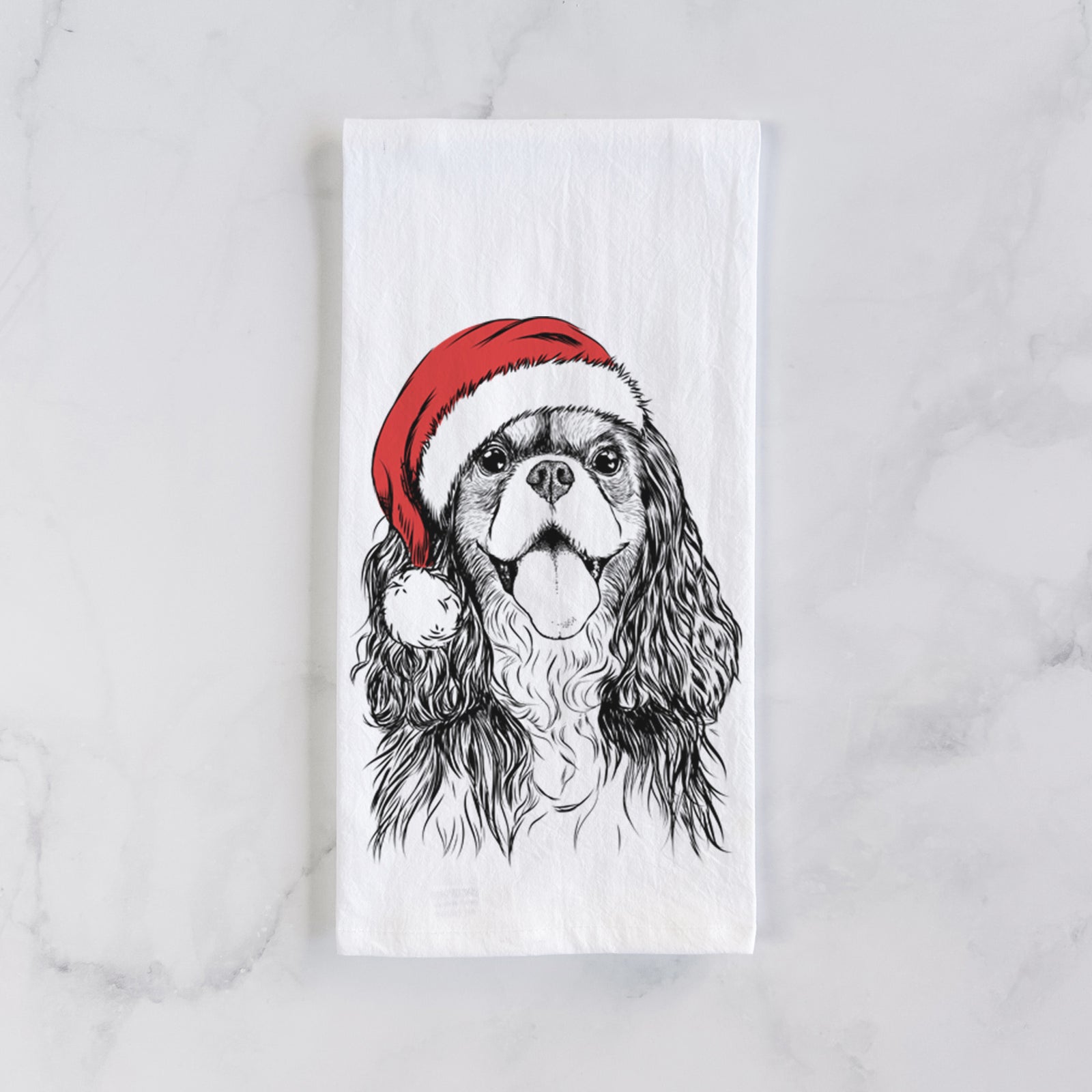 Hand-drawn sketch of Brandy the Cavalier King Charles Spaniel wearing a Santa hat on a tea towel