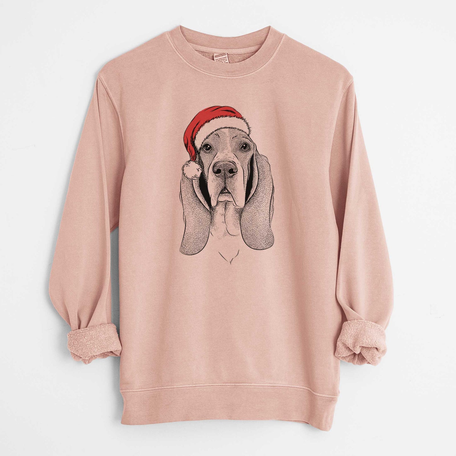 Hand-drawn sketch of Buckley the Basset Hound wearing a Santa hat on a Dusty Pink Unisex pigment dyed crew sweatshirt
