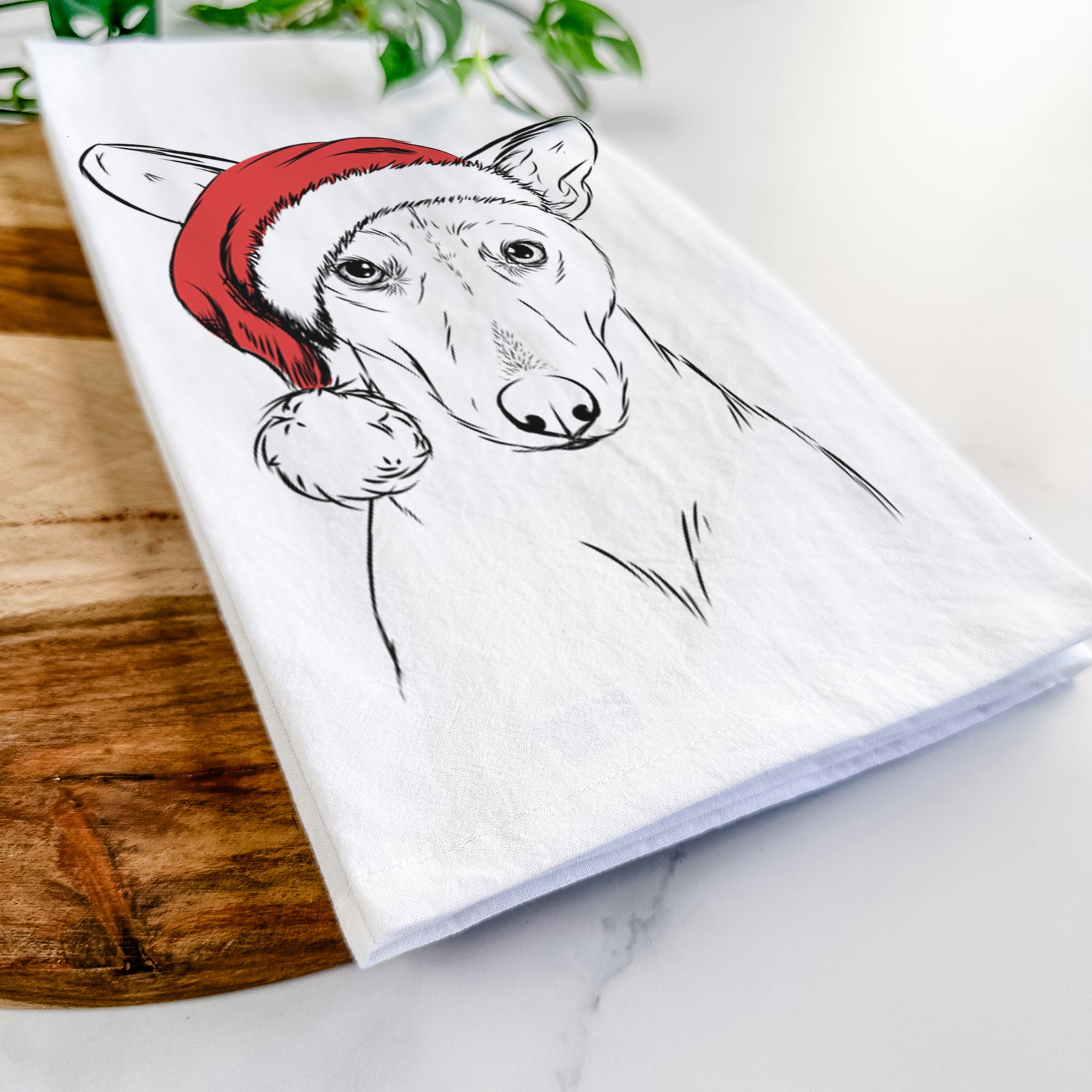 Hand-drawn sketch of Buff the Dorgi wearing a Santa hat on a tea towel