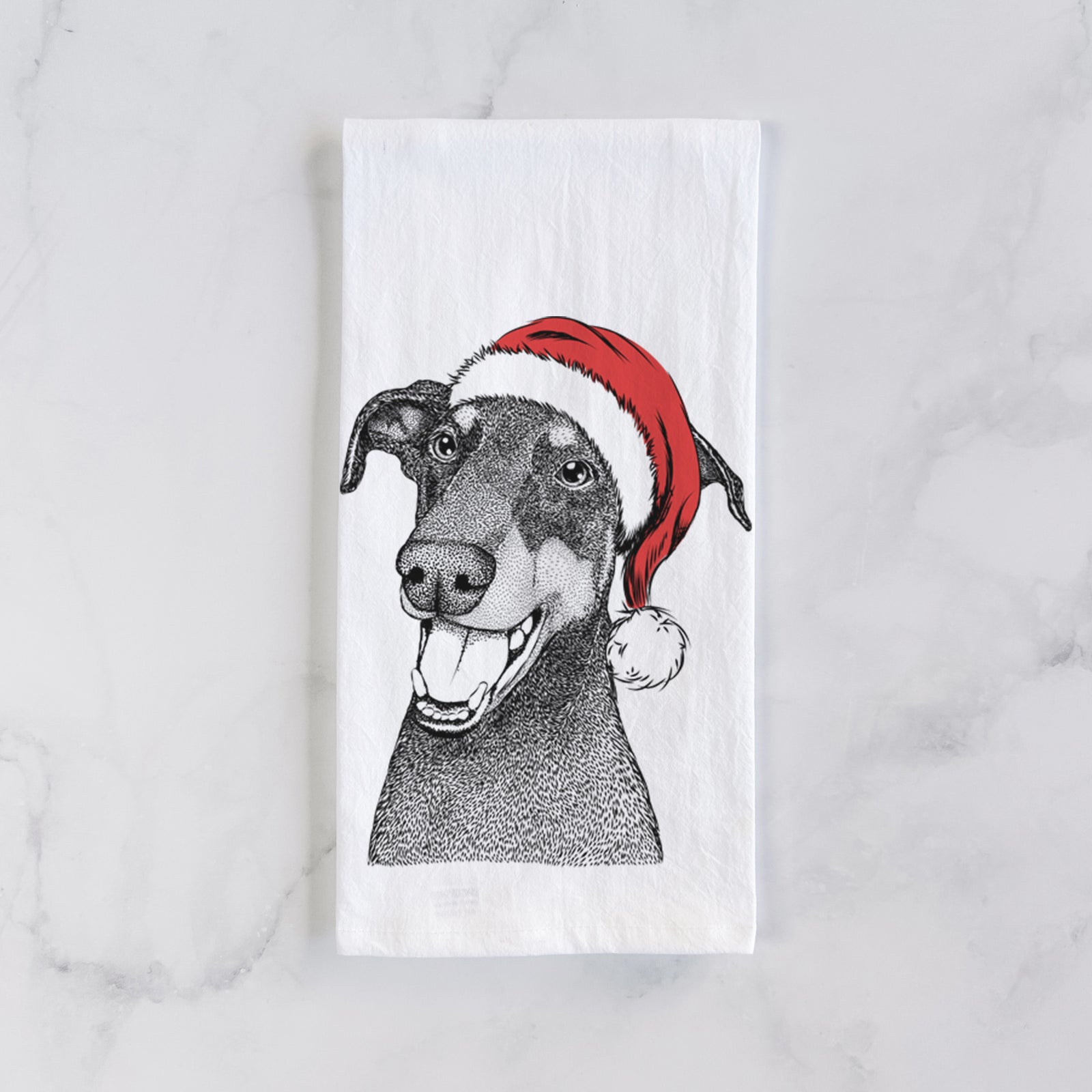 Hand-drawn sketch of Bunnie the Doberman Pinscher wearing a Santa hat on a tea towel