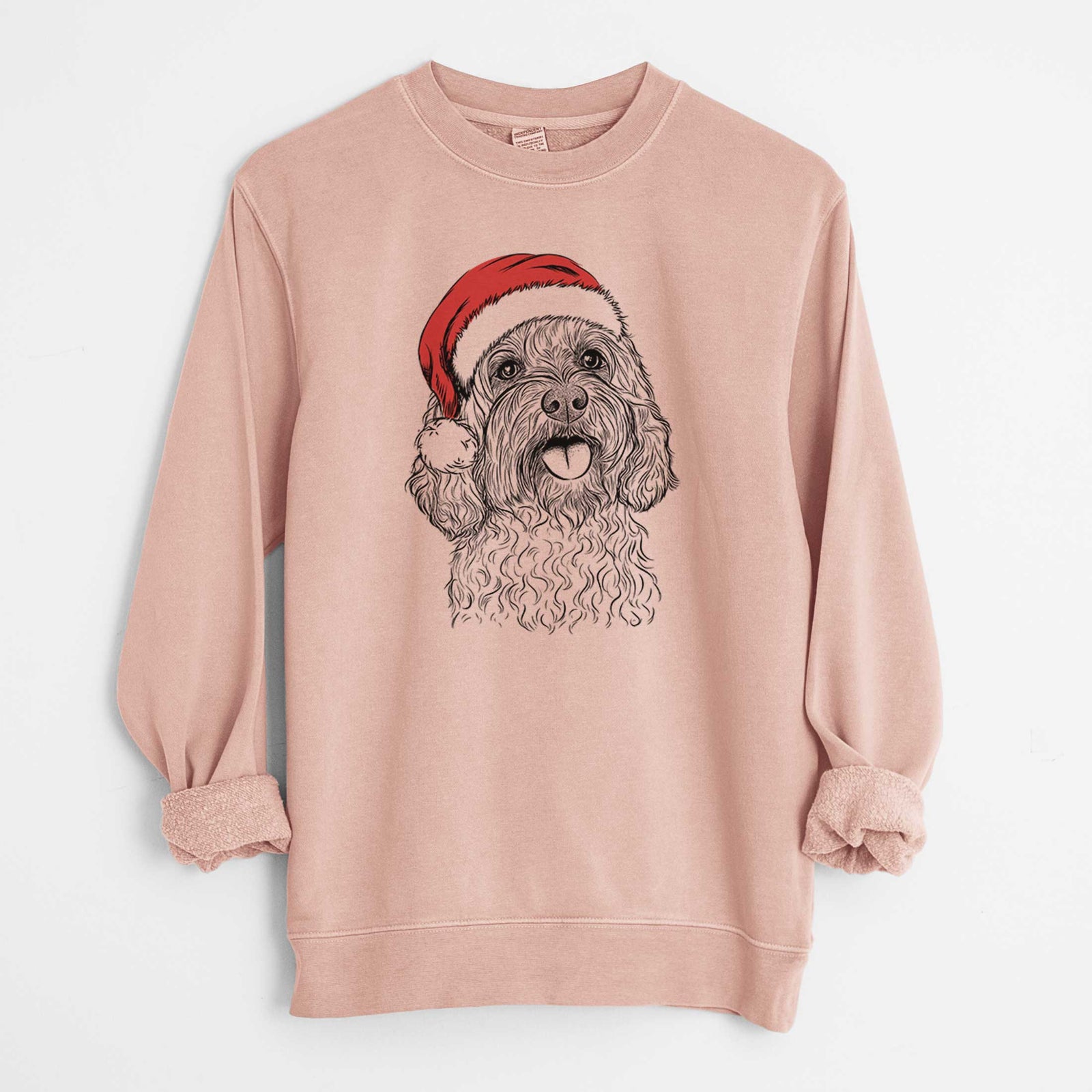 Hand-drawn sketch of Cali the Cavapoo wearing a Santa hat on a Dusty Pink Unisex pigment dyed crew sweatshirt