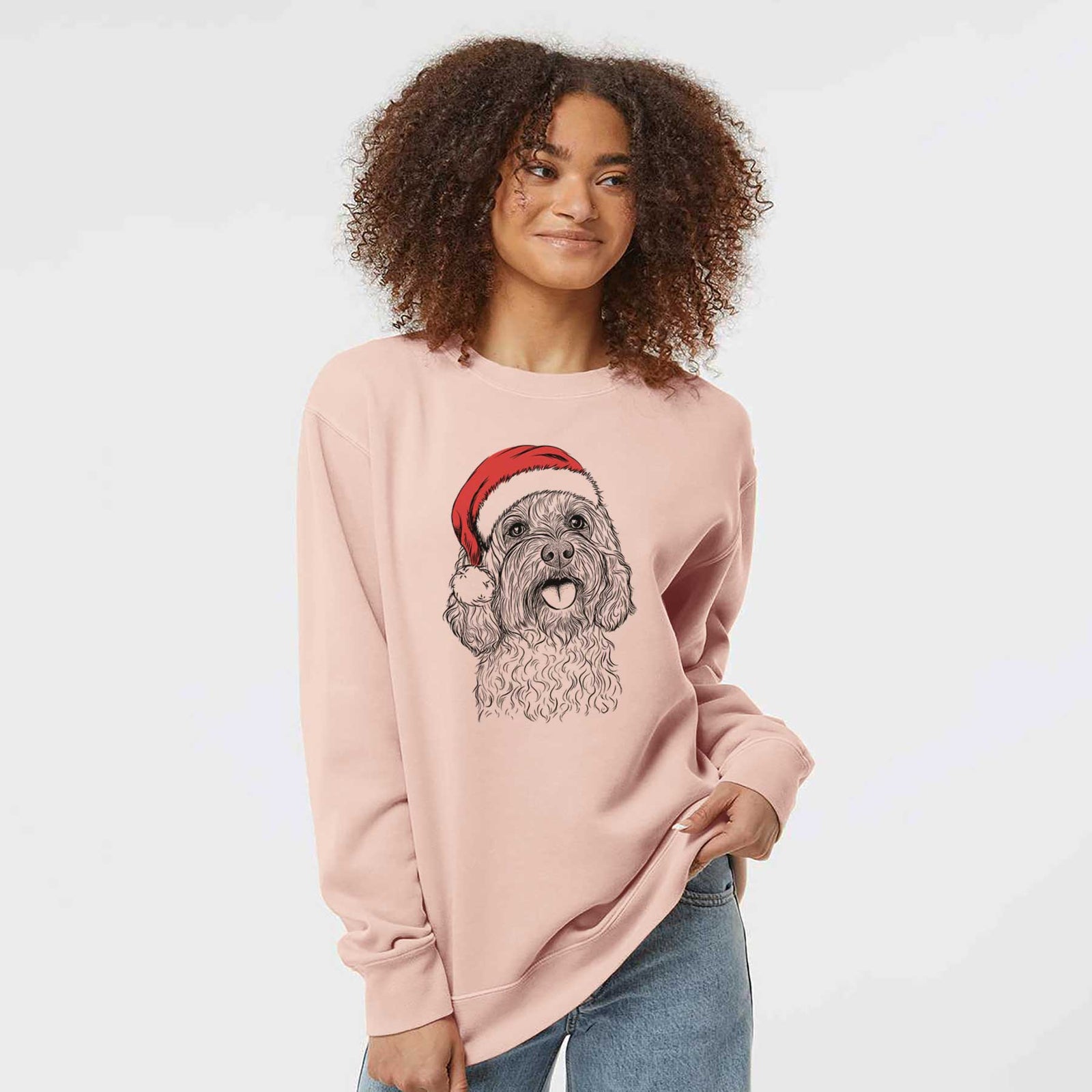 Hand-drawn sketch of Cali the Cavapoo wearing a Santa hat on a Dusty Pink Unisex pigment dyed crew sweatshirt