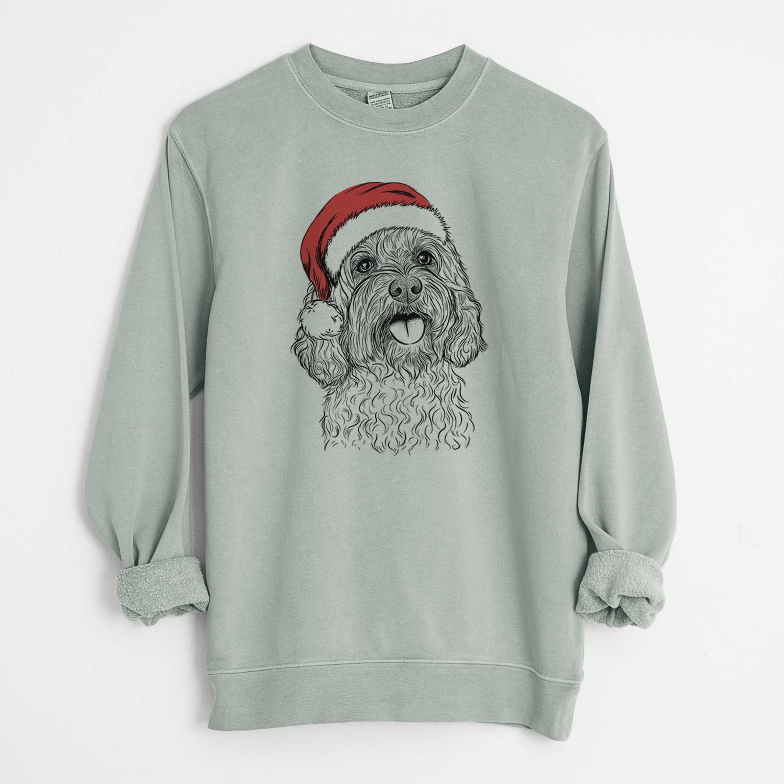Hand-drawn sketch of Cali the Cavapoo wearing a Santa hat on a Sage Unisex pigment dyed crew sweatshirt
