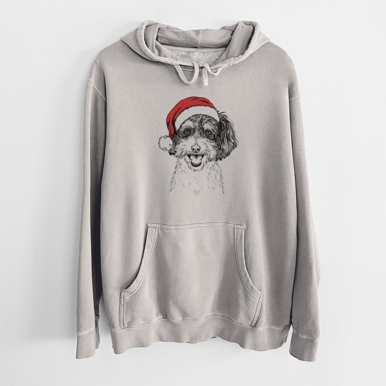 Hand-drawn sketch of Carlos the Cavapoo wearing a Santa hat on a Cement Unisex pigment dyed hoodie