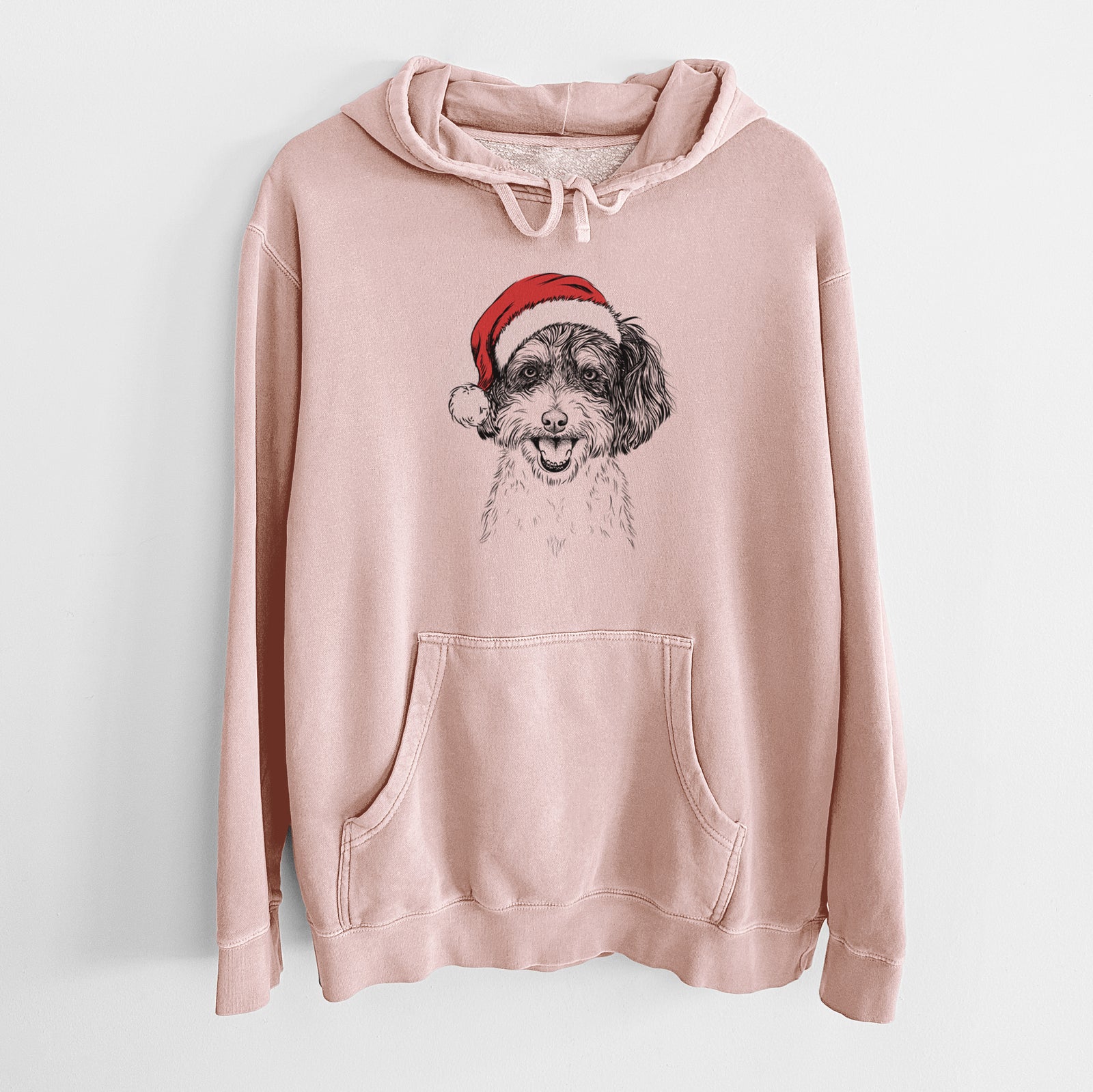 Hand-drawn sketch of Carlos the Cavapoo wearing a Santa hat on a Dusty Pink Unisex pigment dyed hoodie