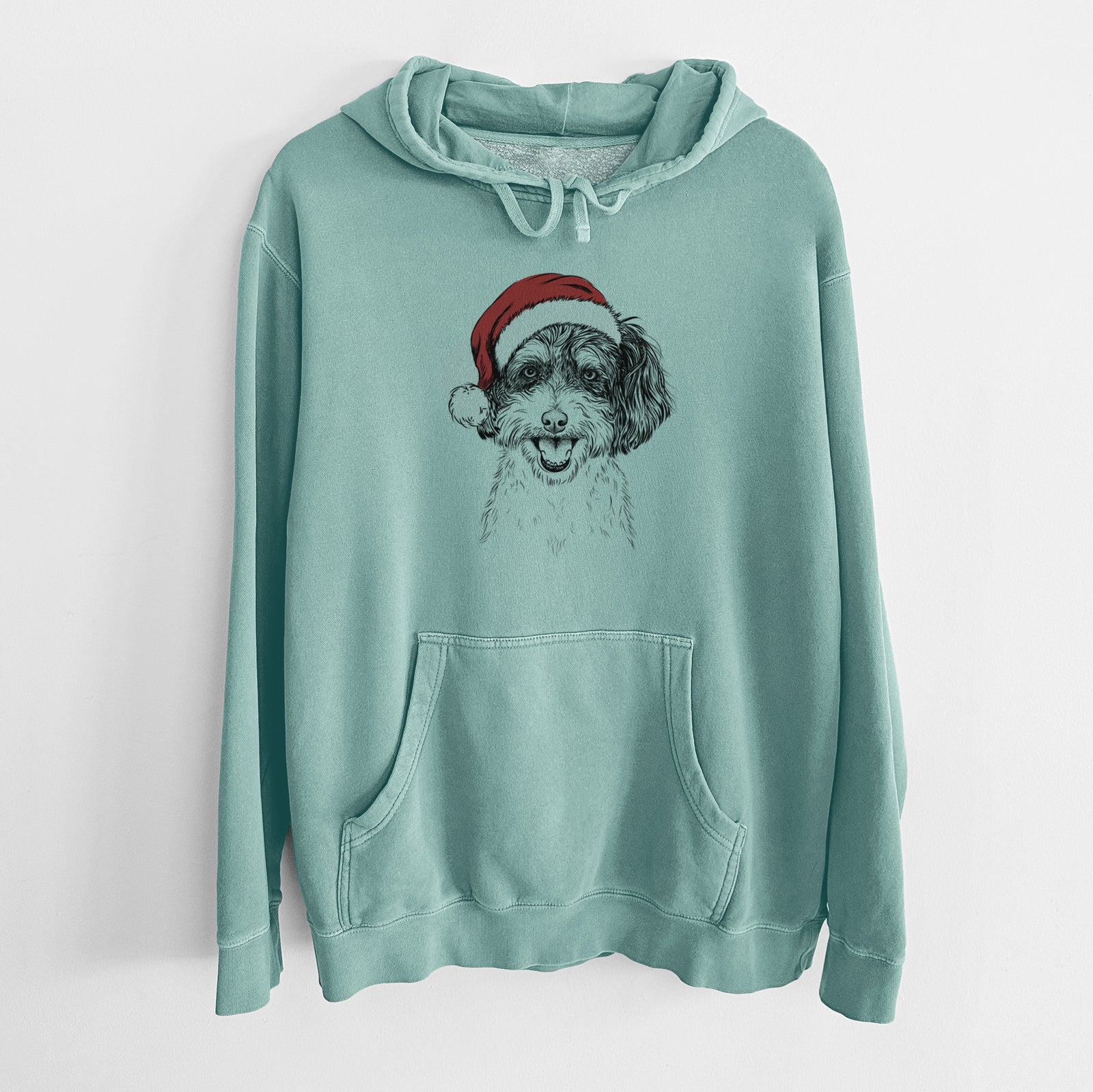 Hand-drawn sketch of Carlos the Cavapoo wearing a Santa hat on a Mint Unisex pigment dyed hoodie