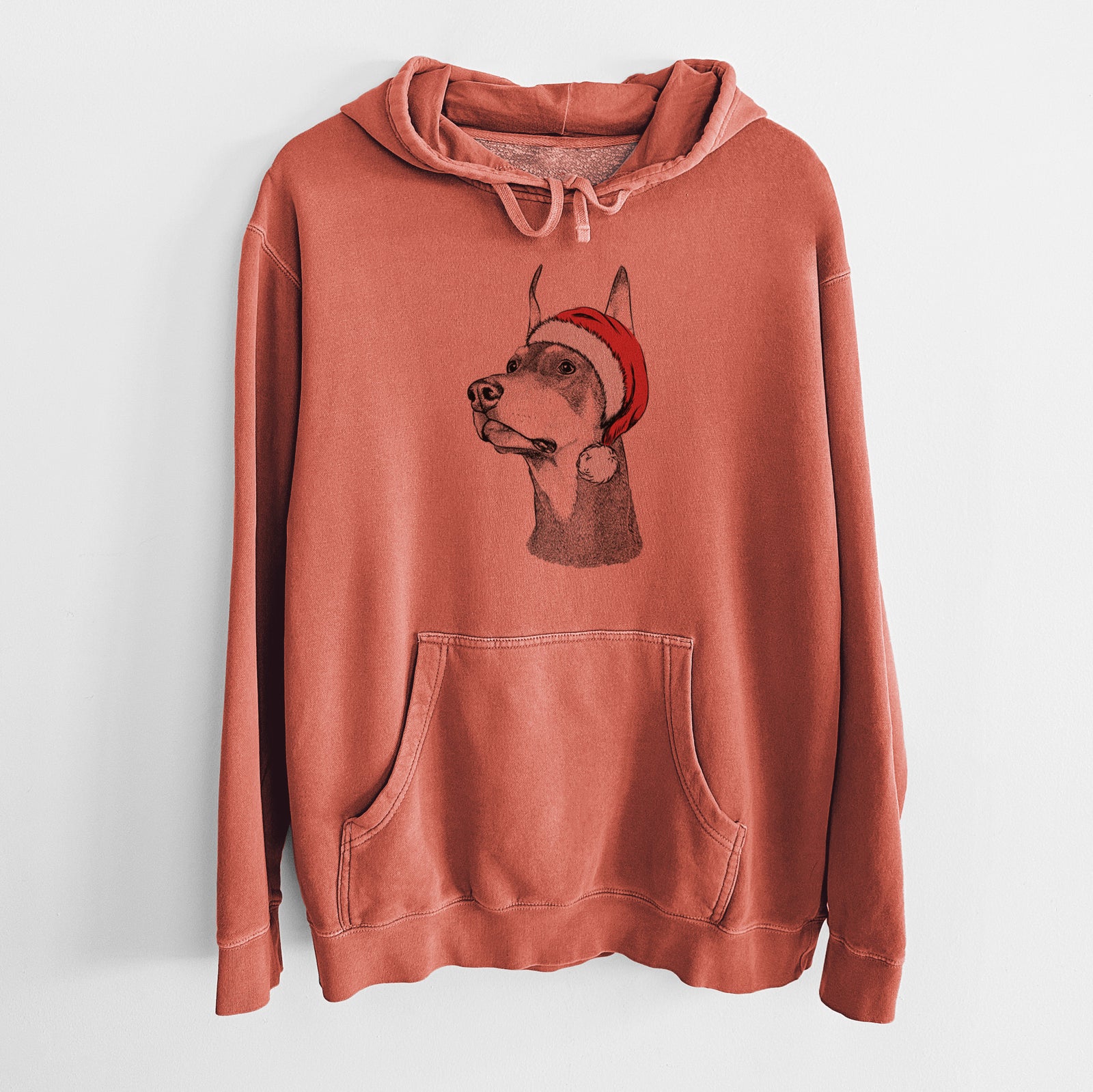 Hand-drawn sketch of Cenza the Doberman Pinscher wearing a Santa hat on an Amber Unisex pigment dyed hoodie